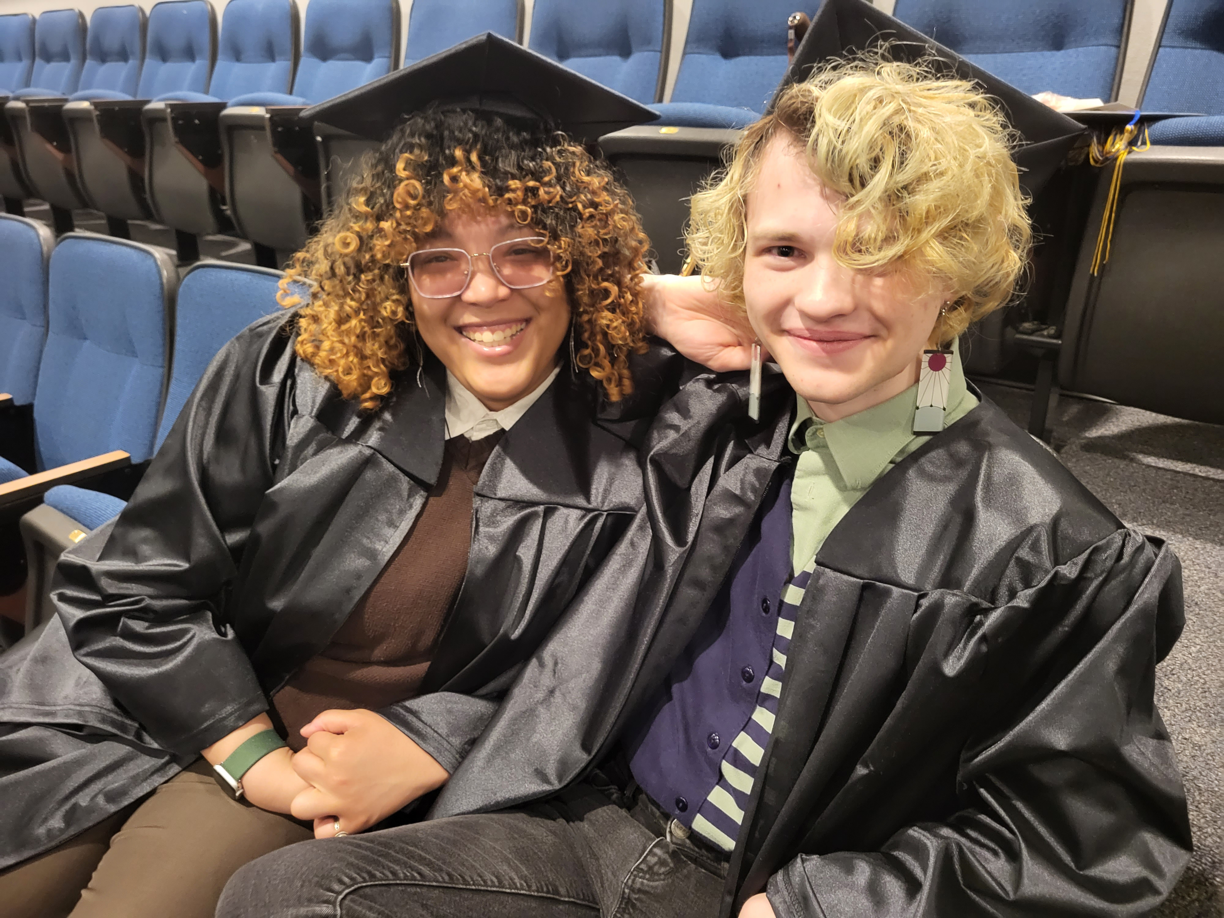 Grads sitting, smiling