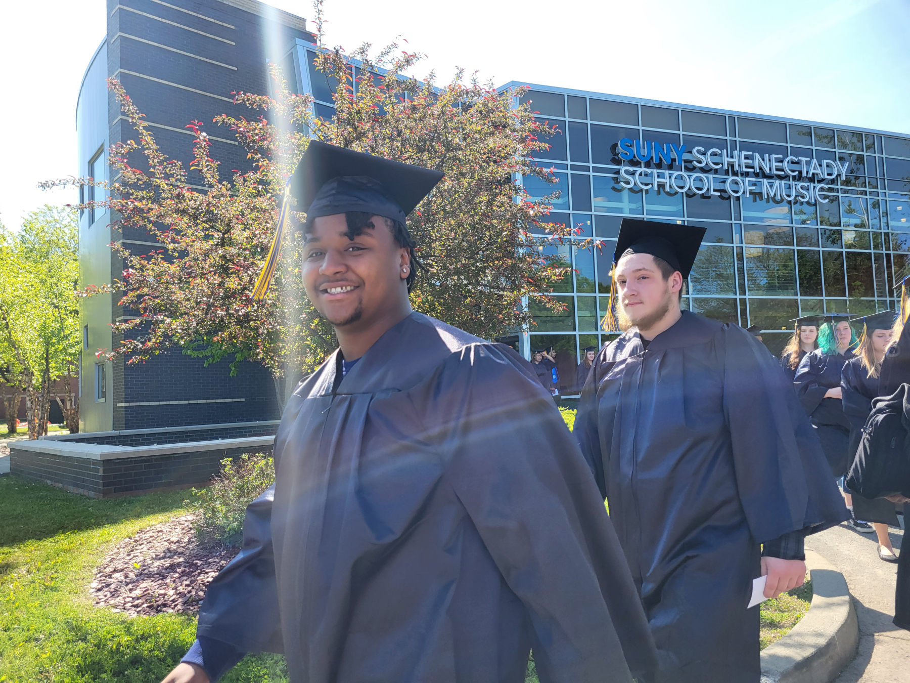 Graduate smiling walking in line