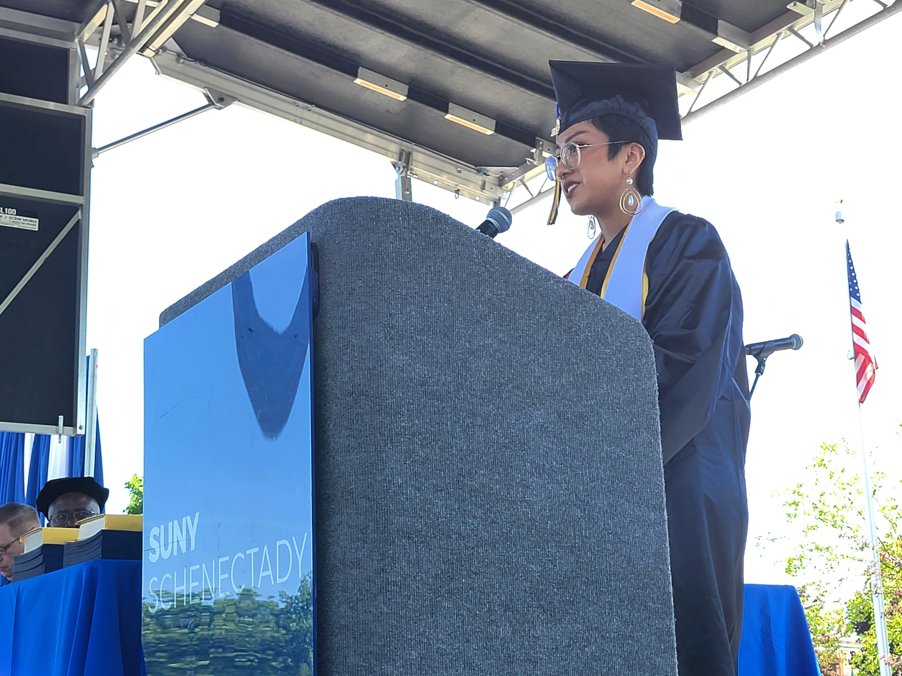 Jennifer Diaz speaking at podium on stage