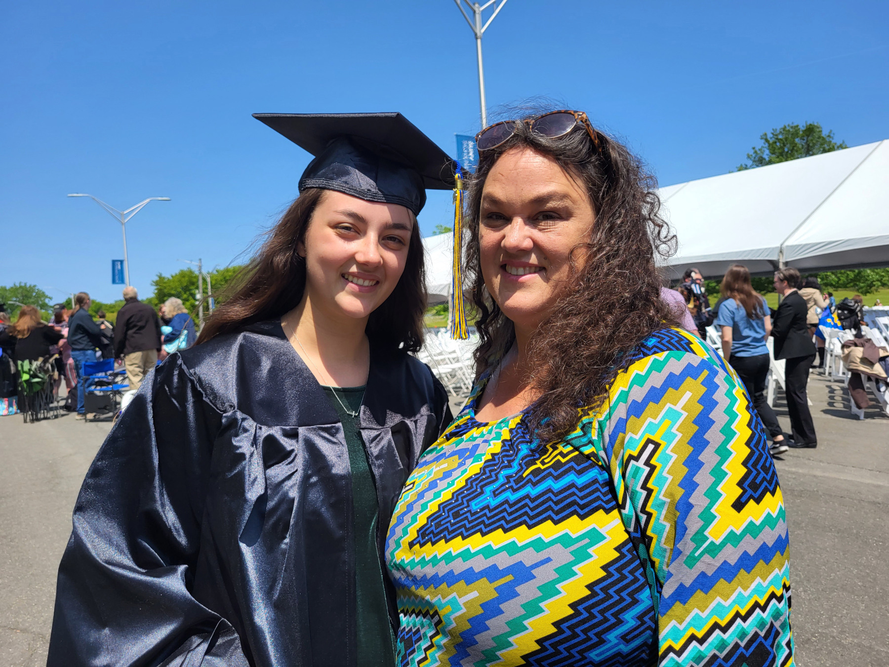 Graduate and parent, smiling