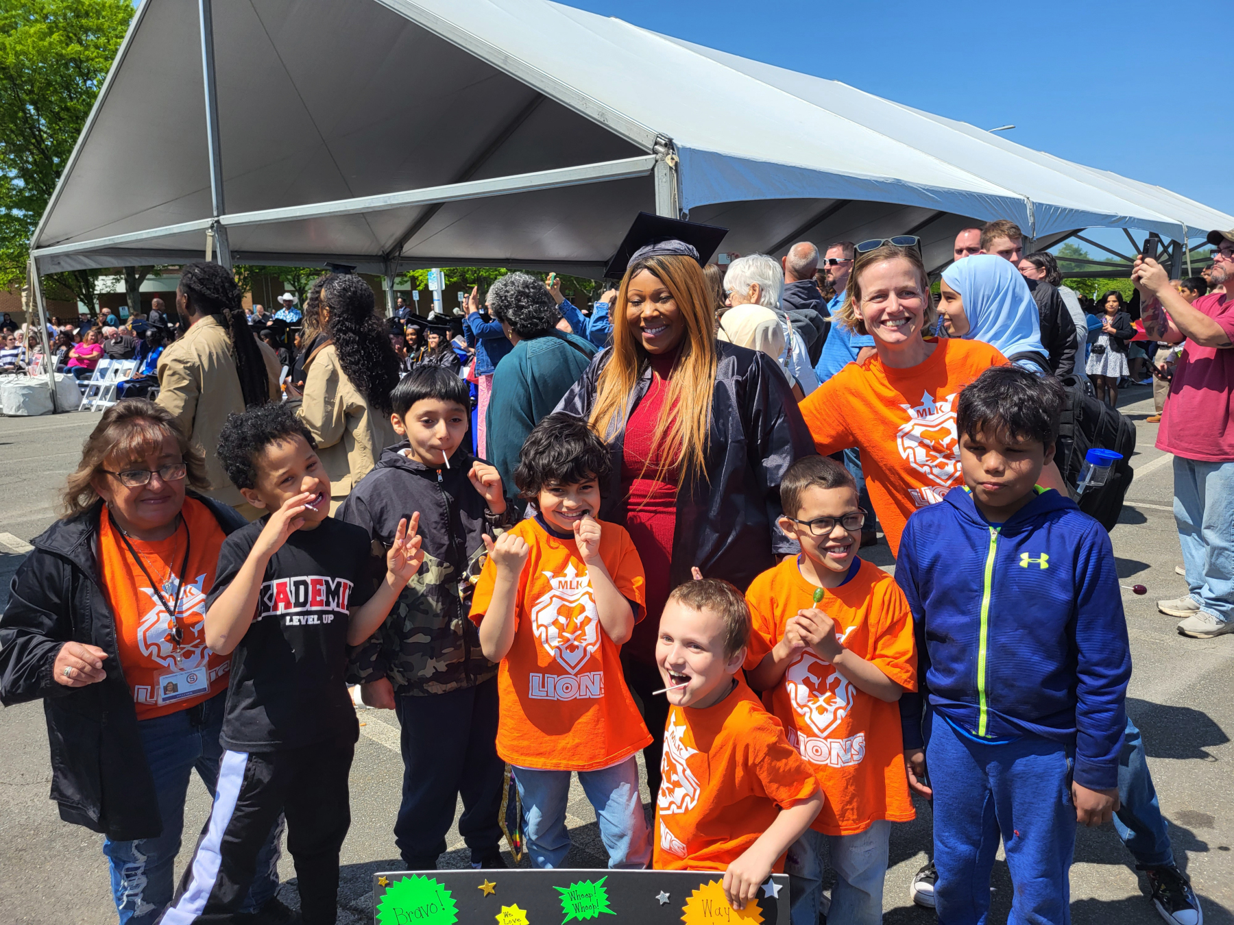 Gradaute hugging children, celebrating after crossing stage