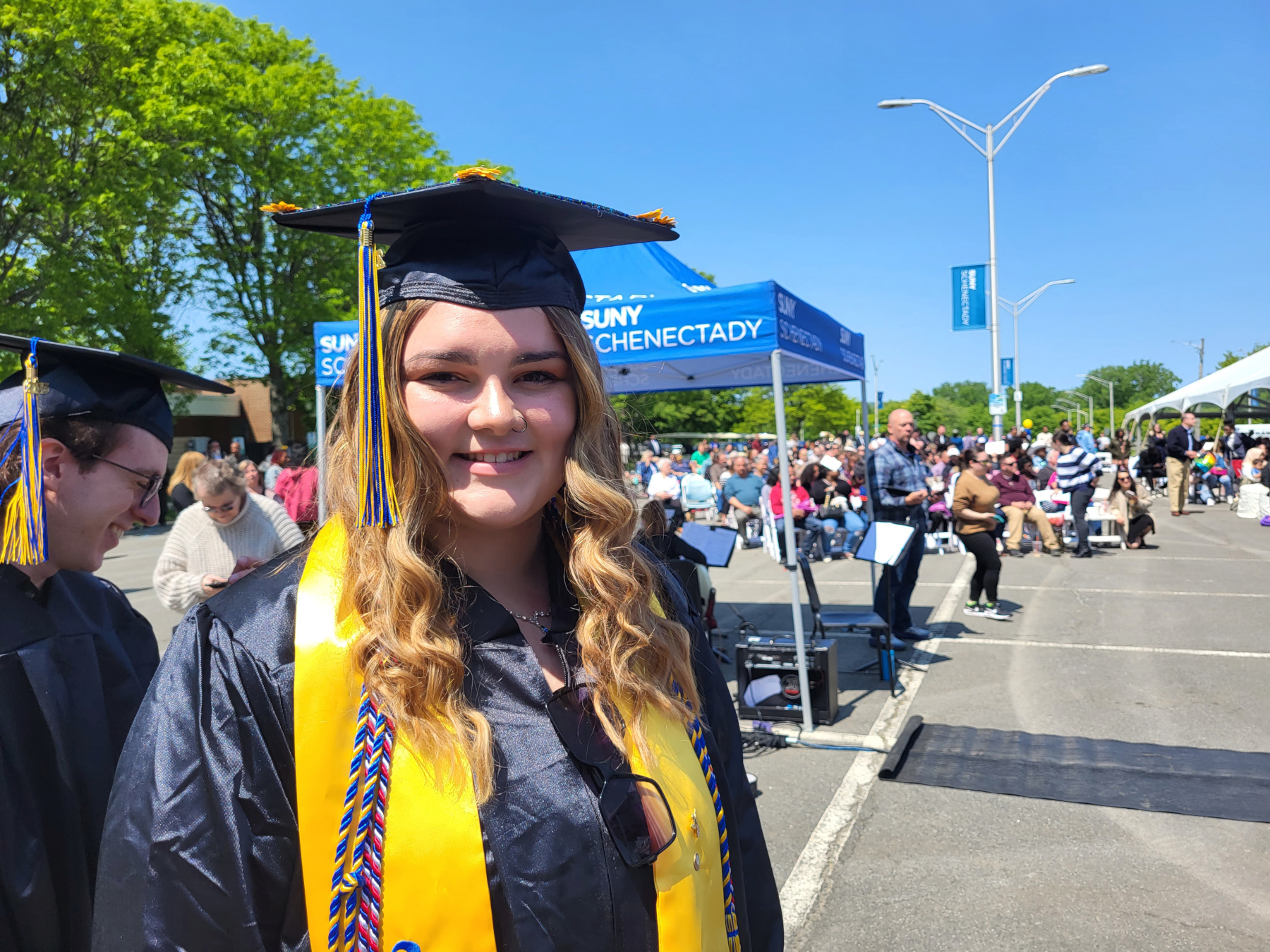 Graduate smiling outside