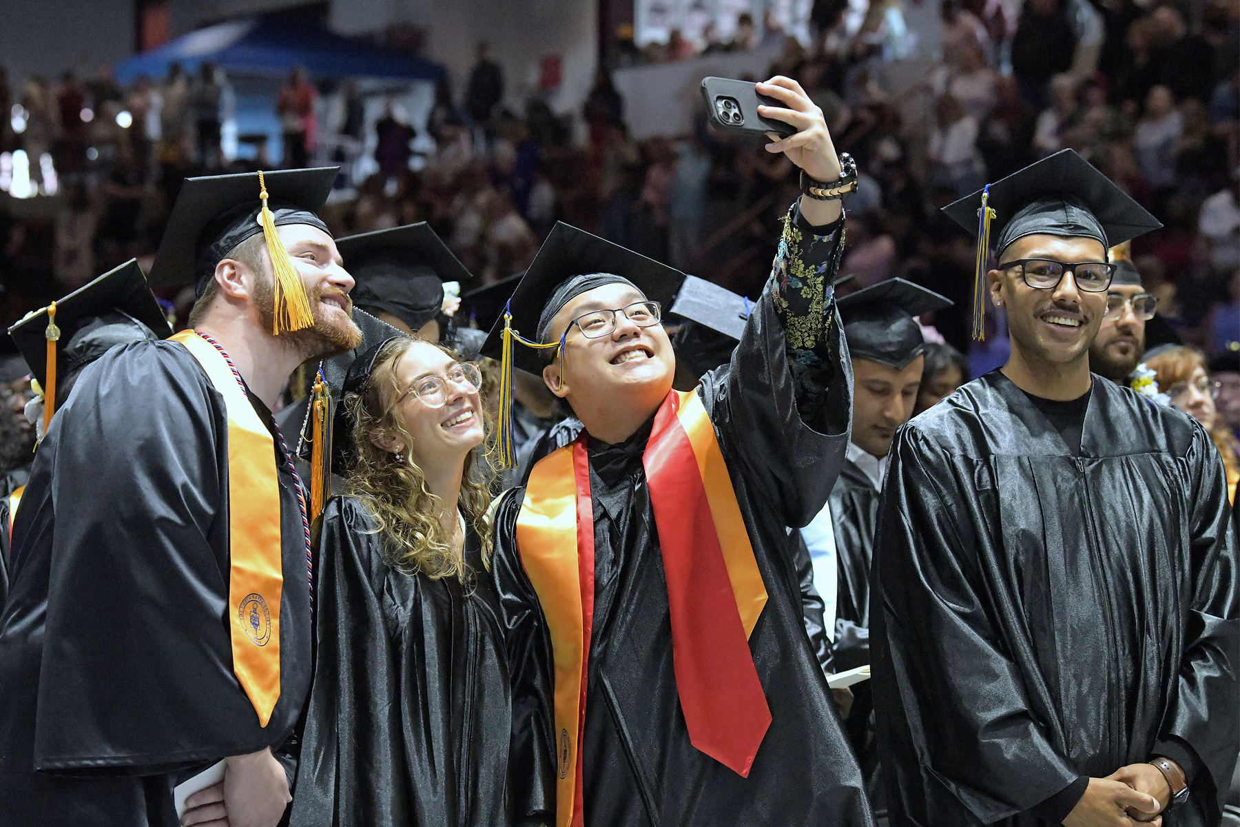 Graduates celebrating during Commencement 2026 inside the M&T Bank Center