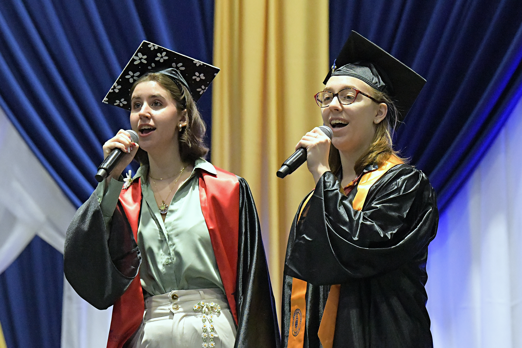 Students on stage signing The Star-Spangled Banner