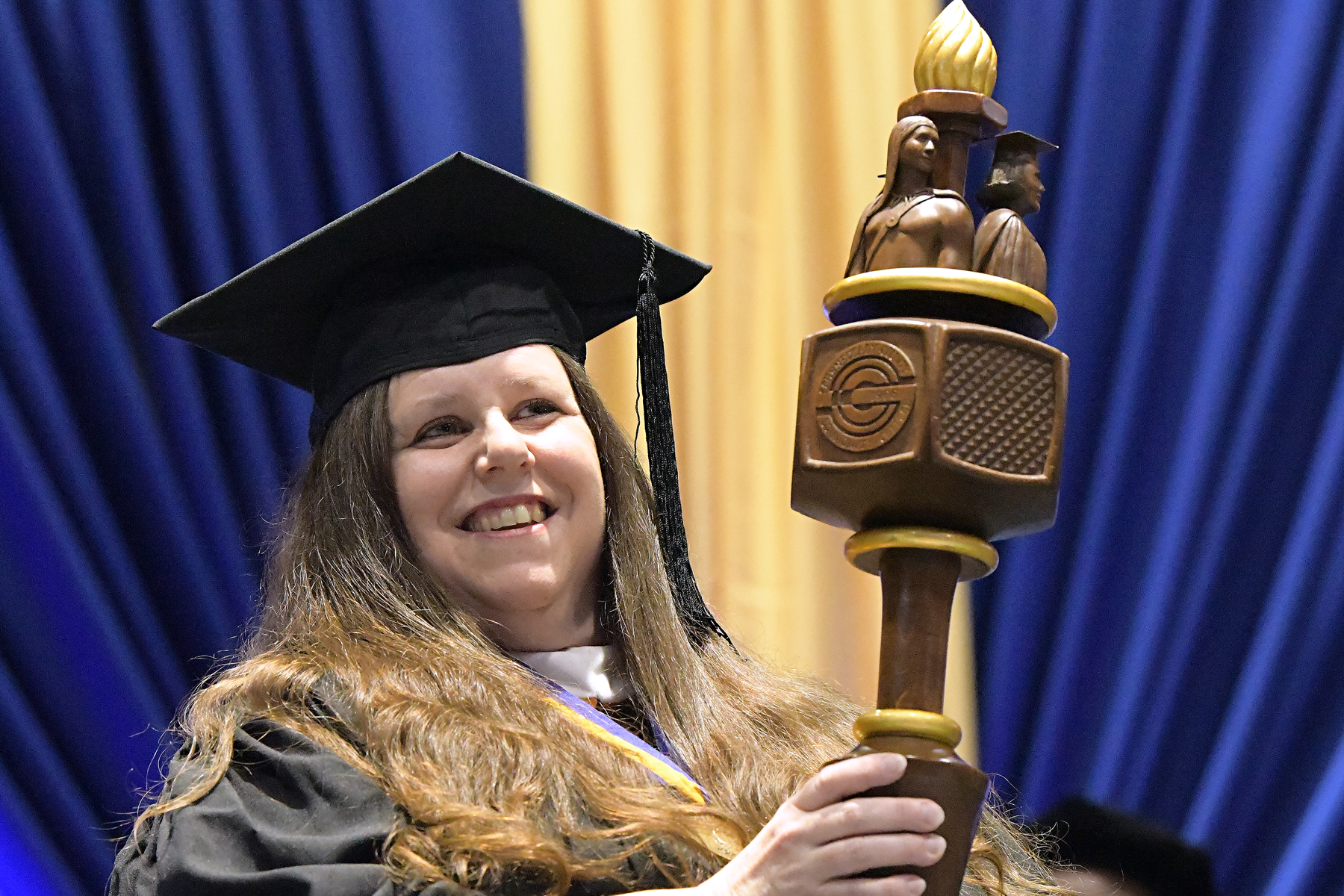 Professor Rae Doyle carrying mace