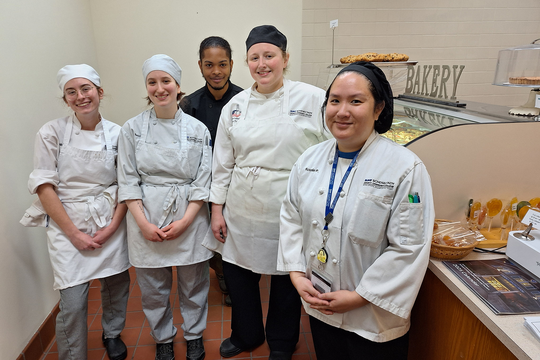 Faculty and students standing inside bakery