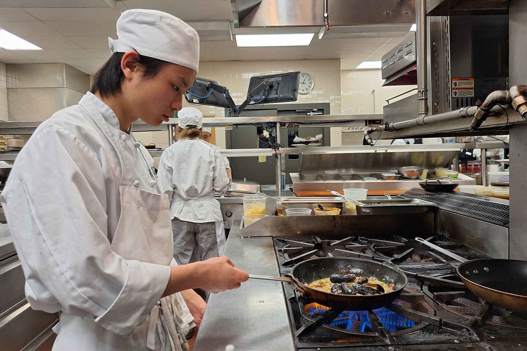 Student cooking in Culinary Lab