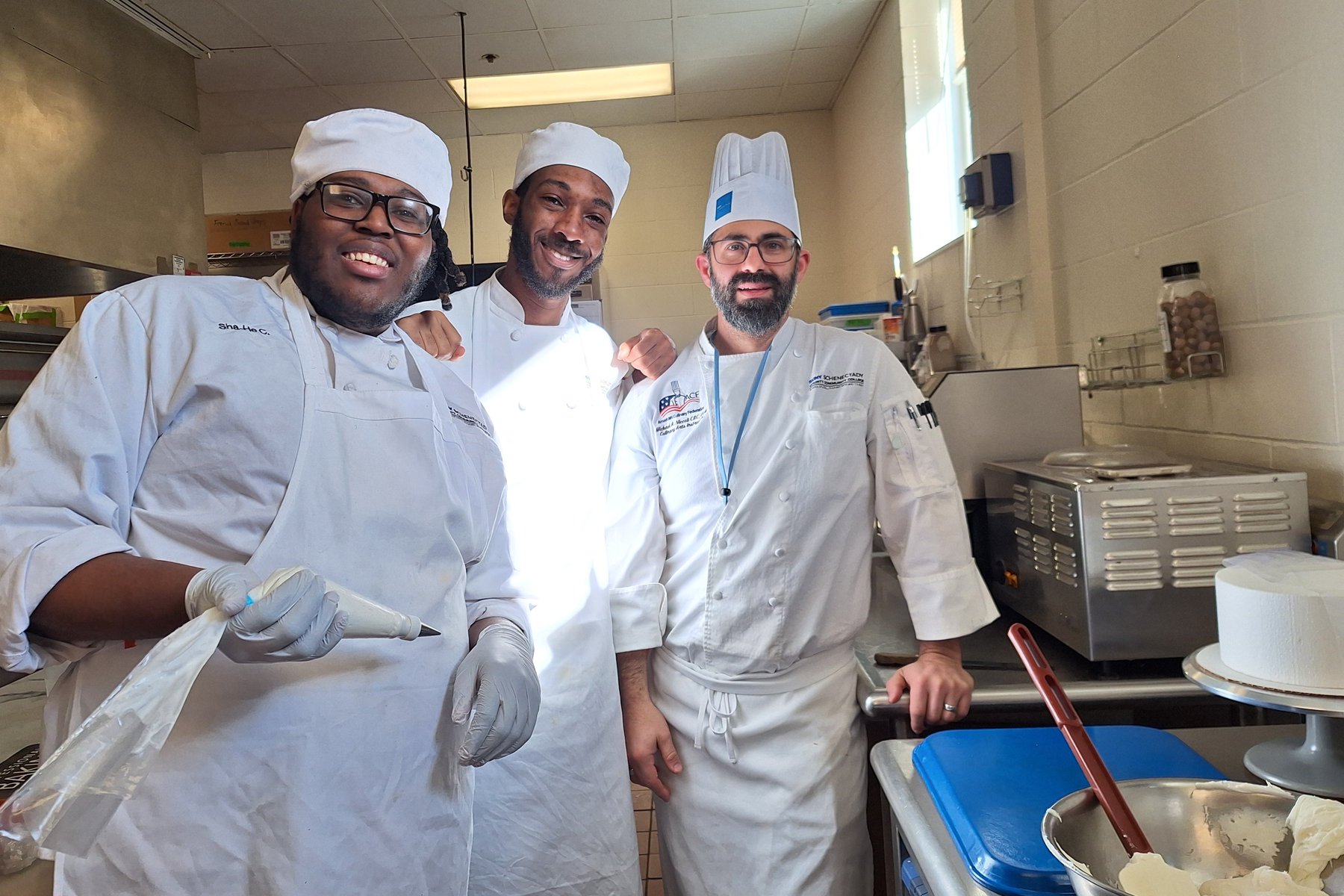 Two students with Instructor Mike Niccoli in Baking Lab