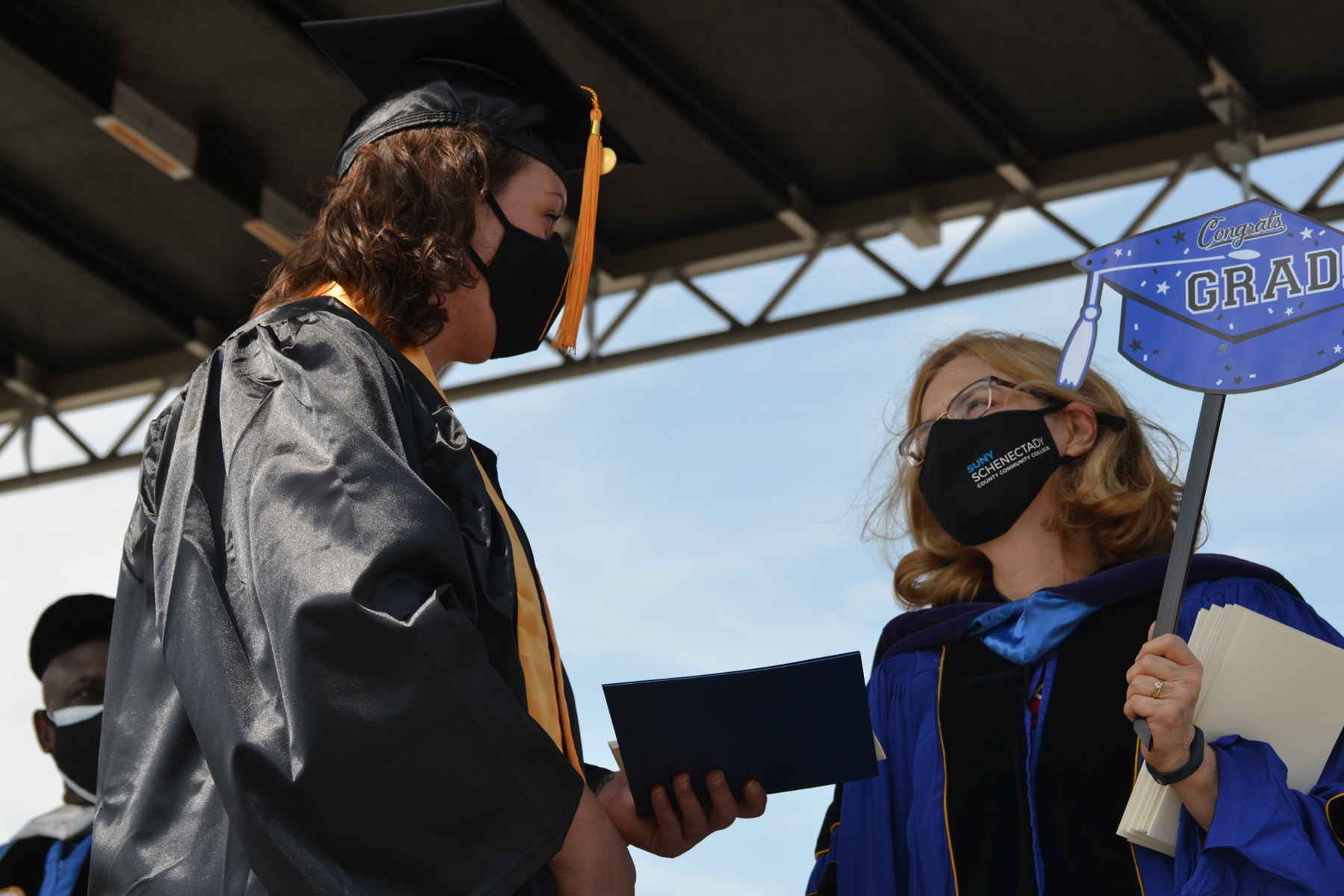 Graduate on stage with Ann Fleming Brown