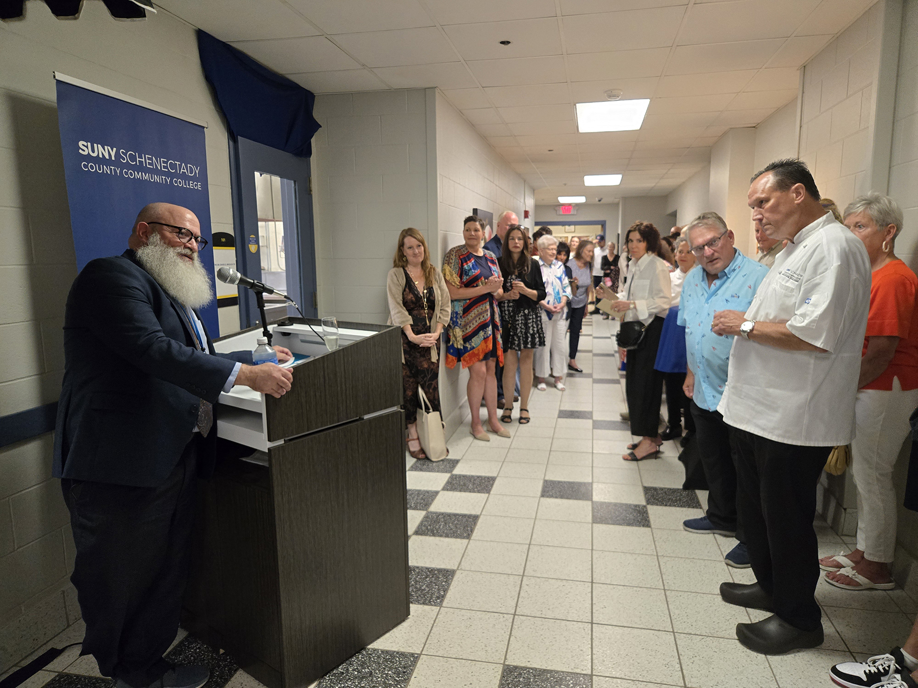 People lining Culinary Arts Wing hallway near Culinary Lab.
