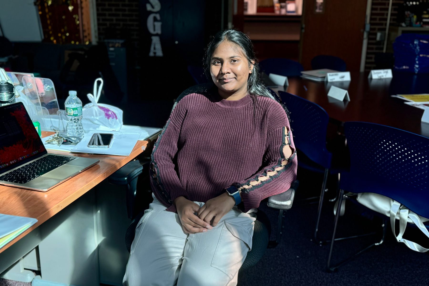 Deviyani Singh seated at table, smiling