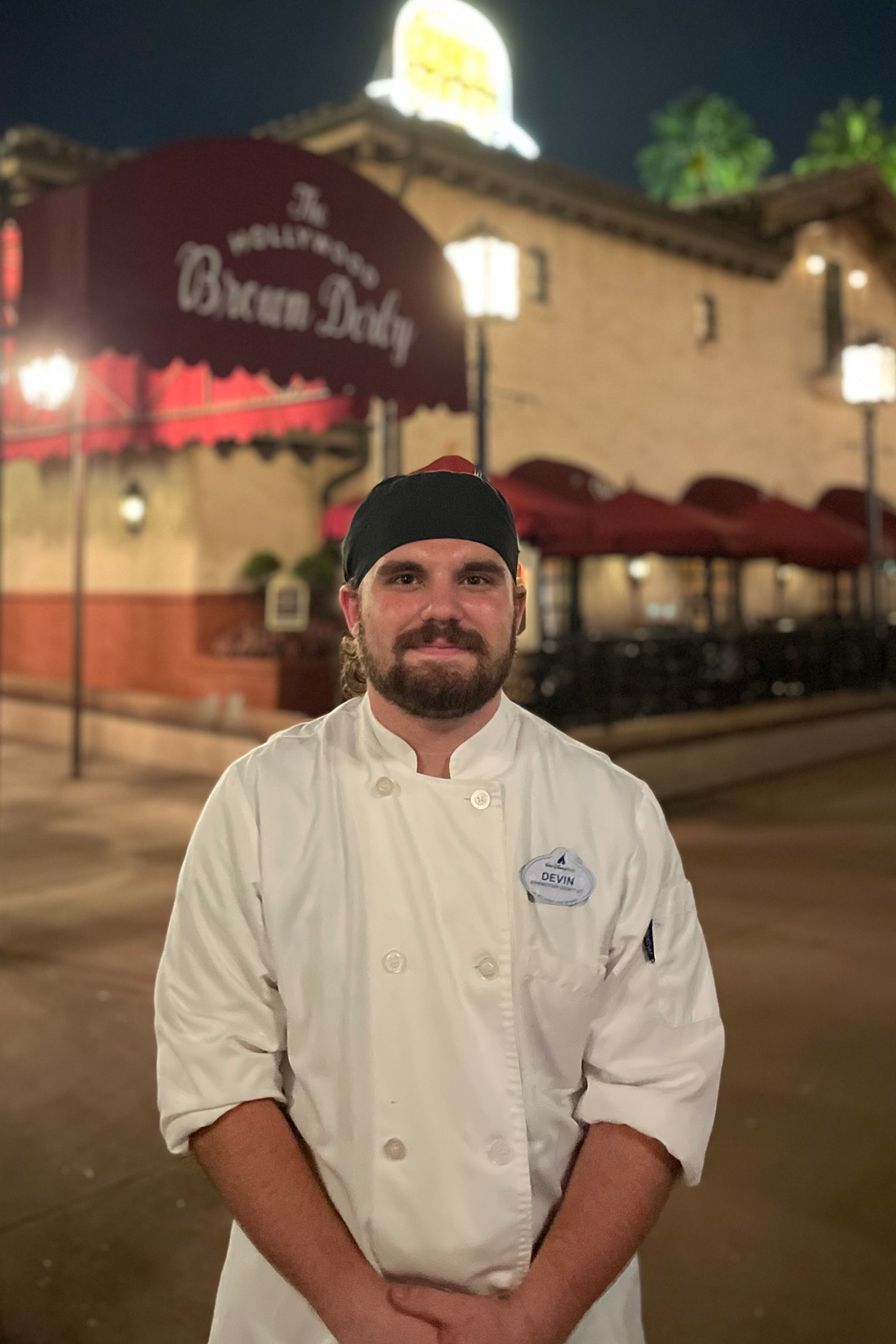 Devin Hershberger in his uniform standing outside in front of Brown Derby Restaurant