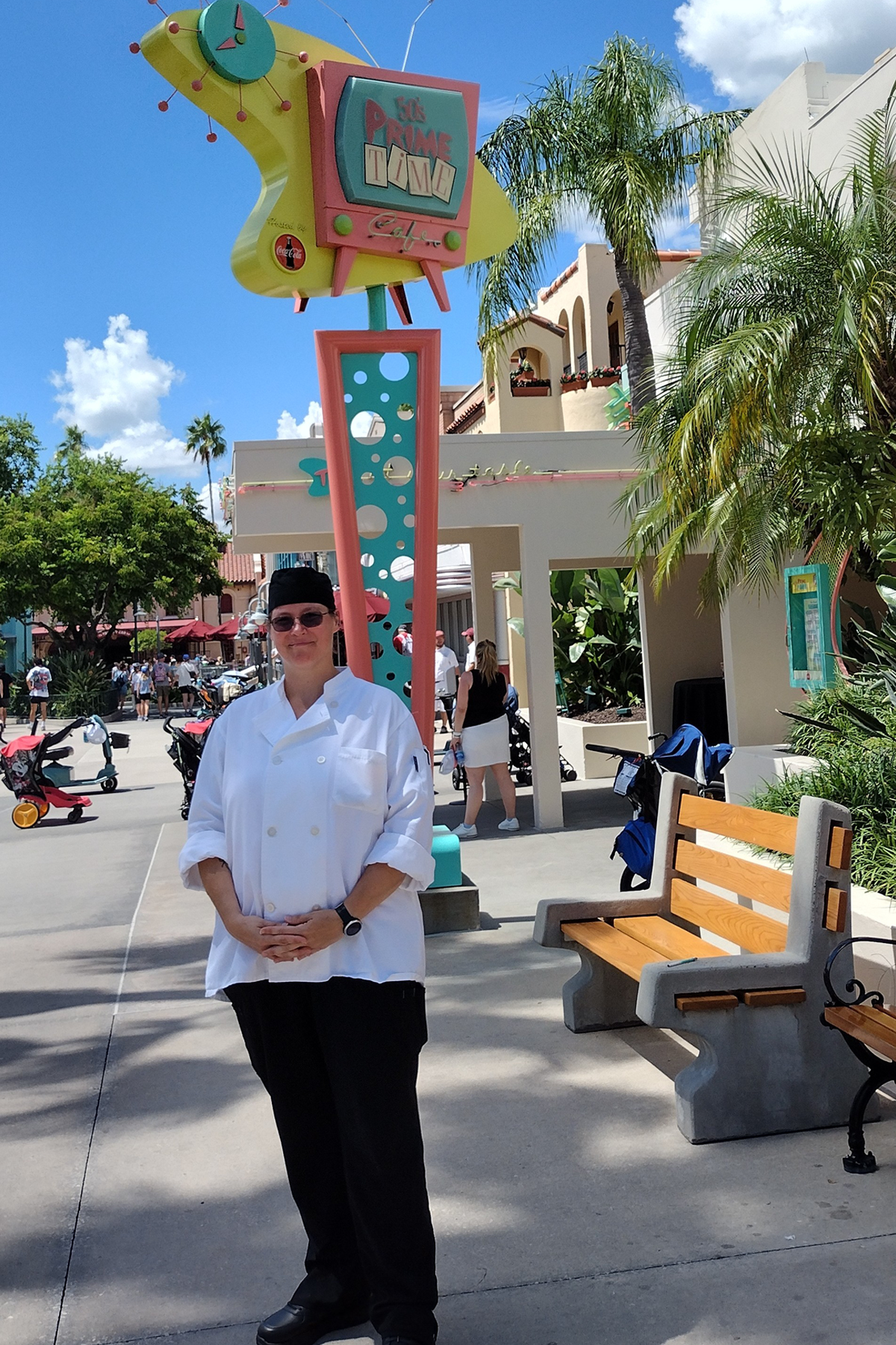 Betty Hassinger in her uniform, standing outside in front of restaurant at Disney