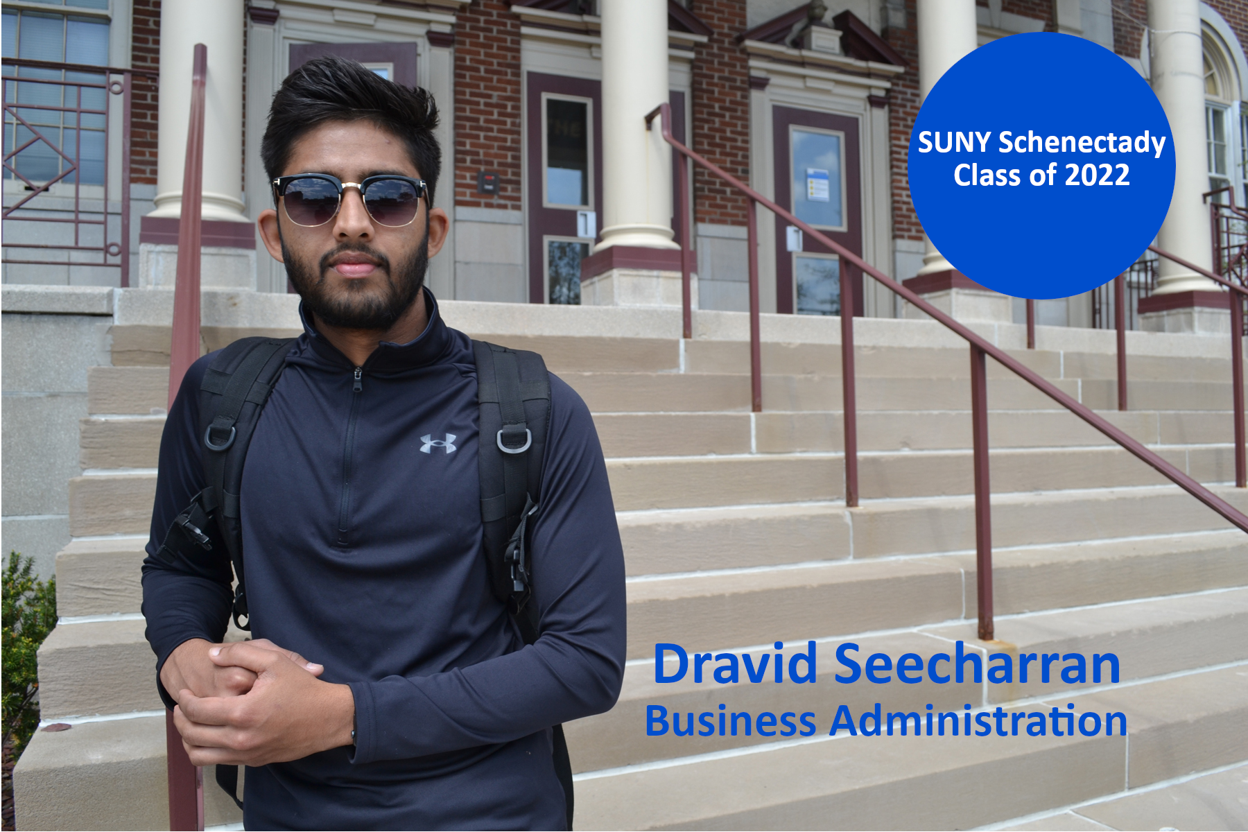 Dravid Seecharran standing on the front steps of Elston Hall