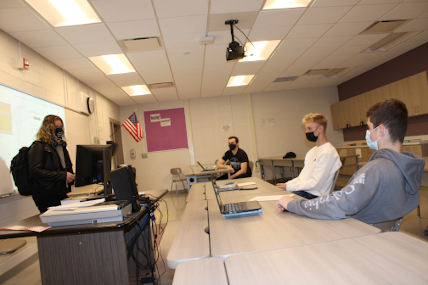 Duanesburg Jr./Sr. High School teacher Rebecca Pless discusses a novel with her students during a College in the High School (CHS) English 123 College Composition class. Clockwise from the left are Pless, Frankie Milos, Nicholas Perillo, and Matthew Coons.