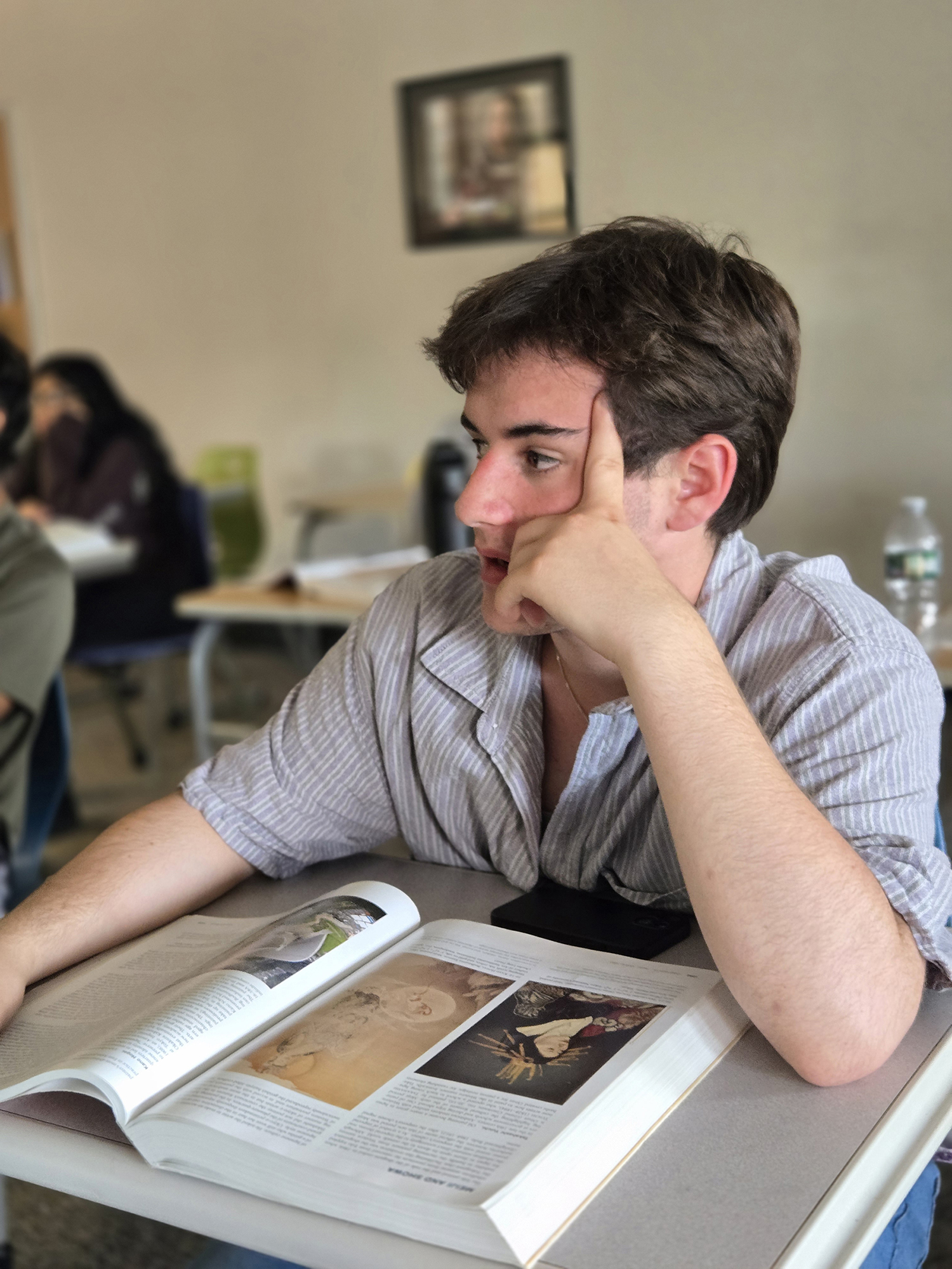 Ethan Brougham sitting at desk during class