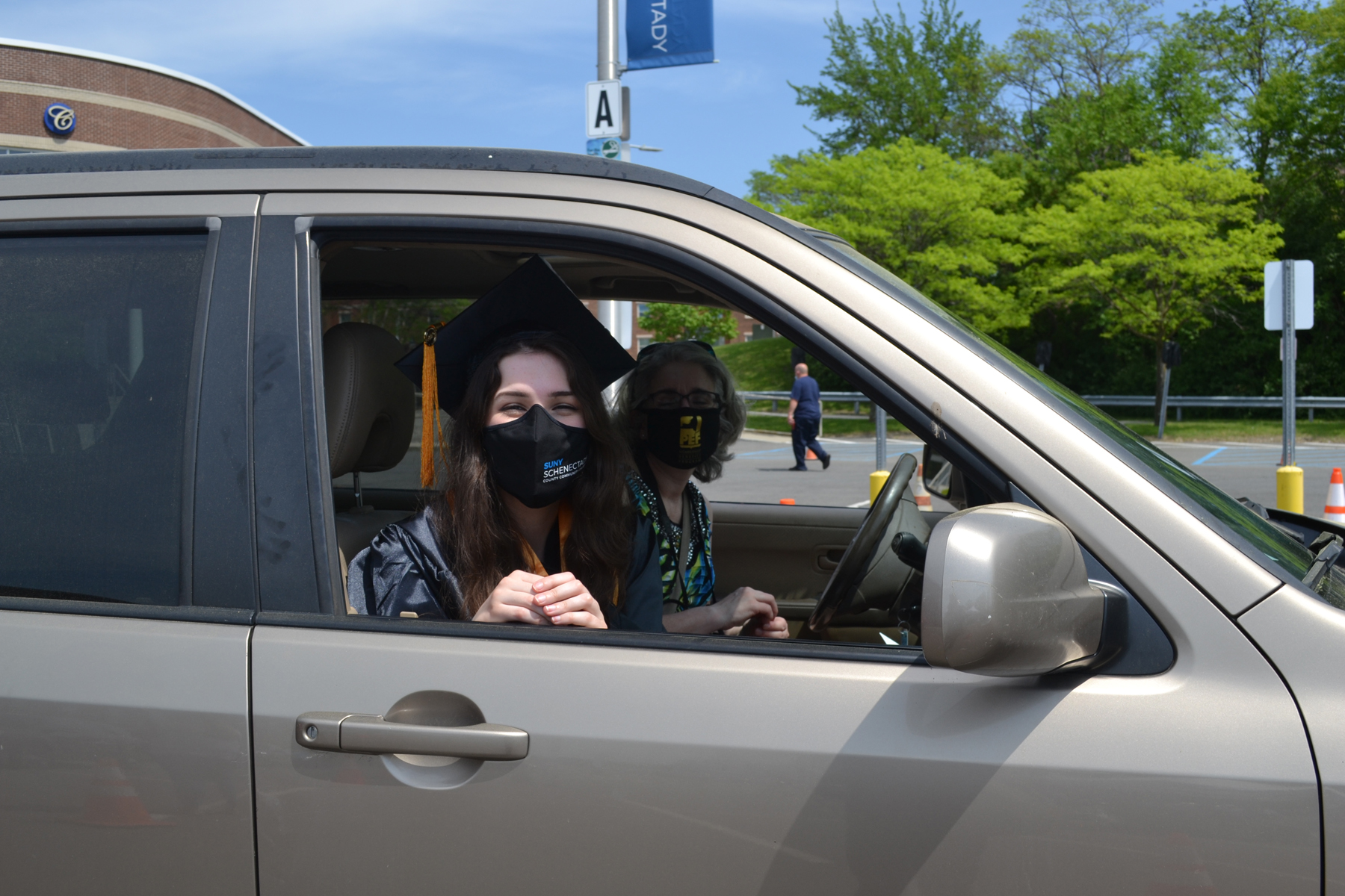 Emily Baker, graduate, in car