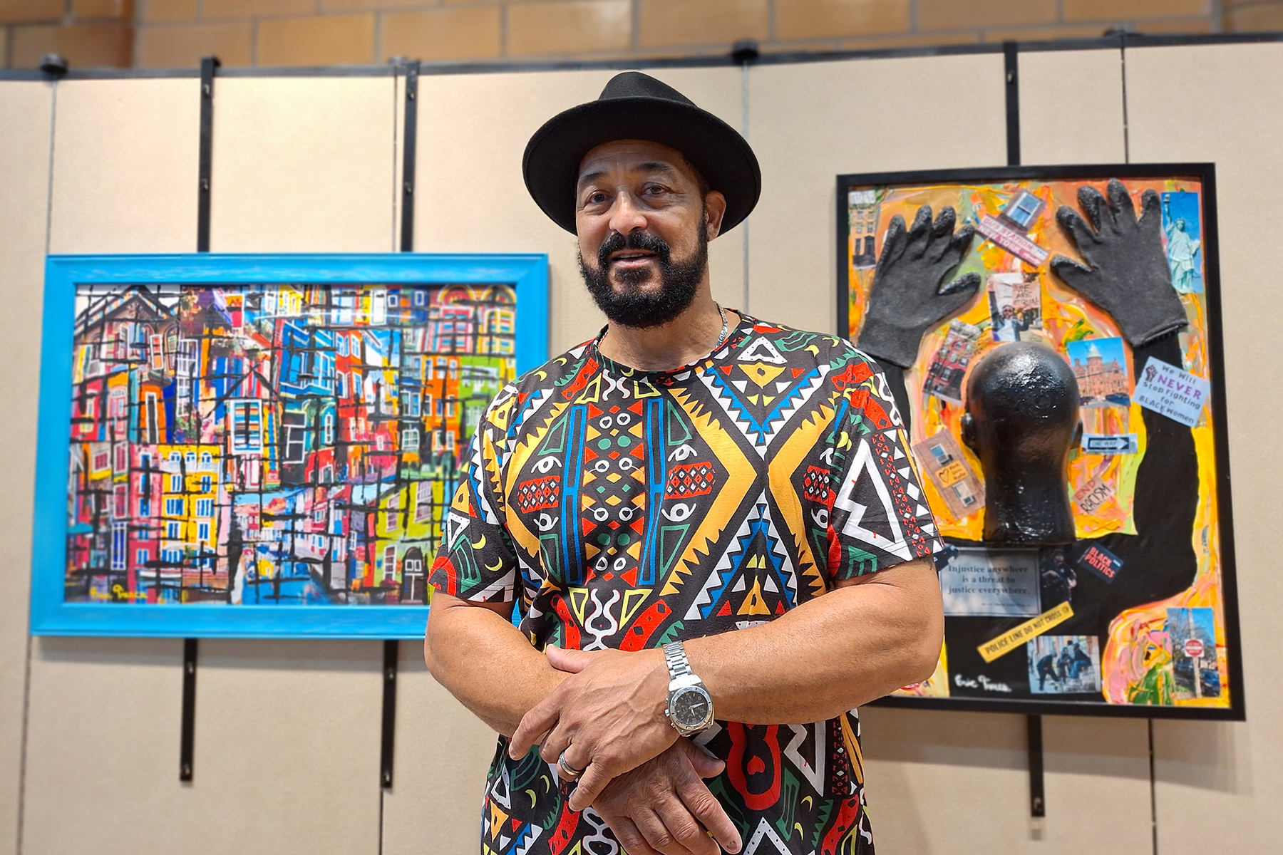 Eric Treece standing in front of his artwork