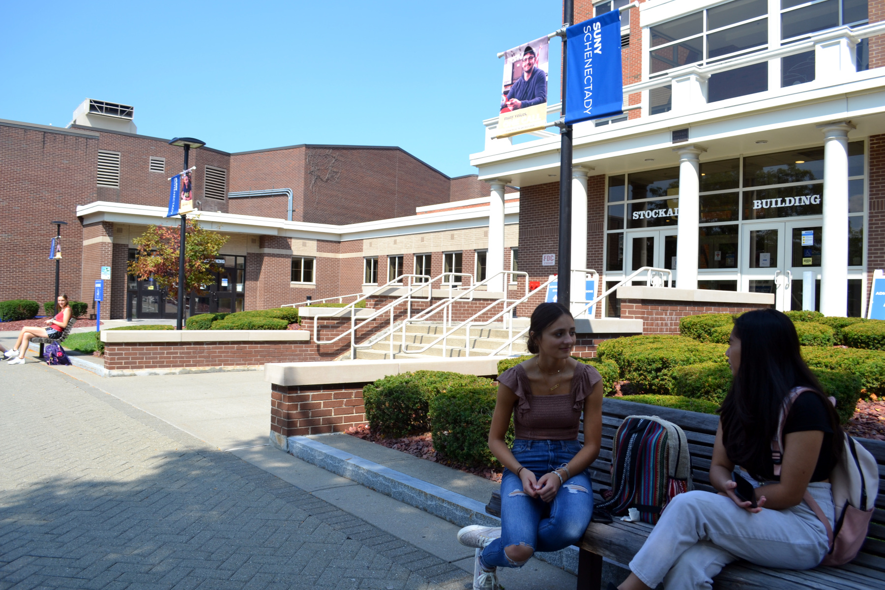 Students sitting on a bench in the quad