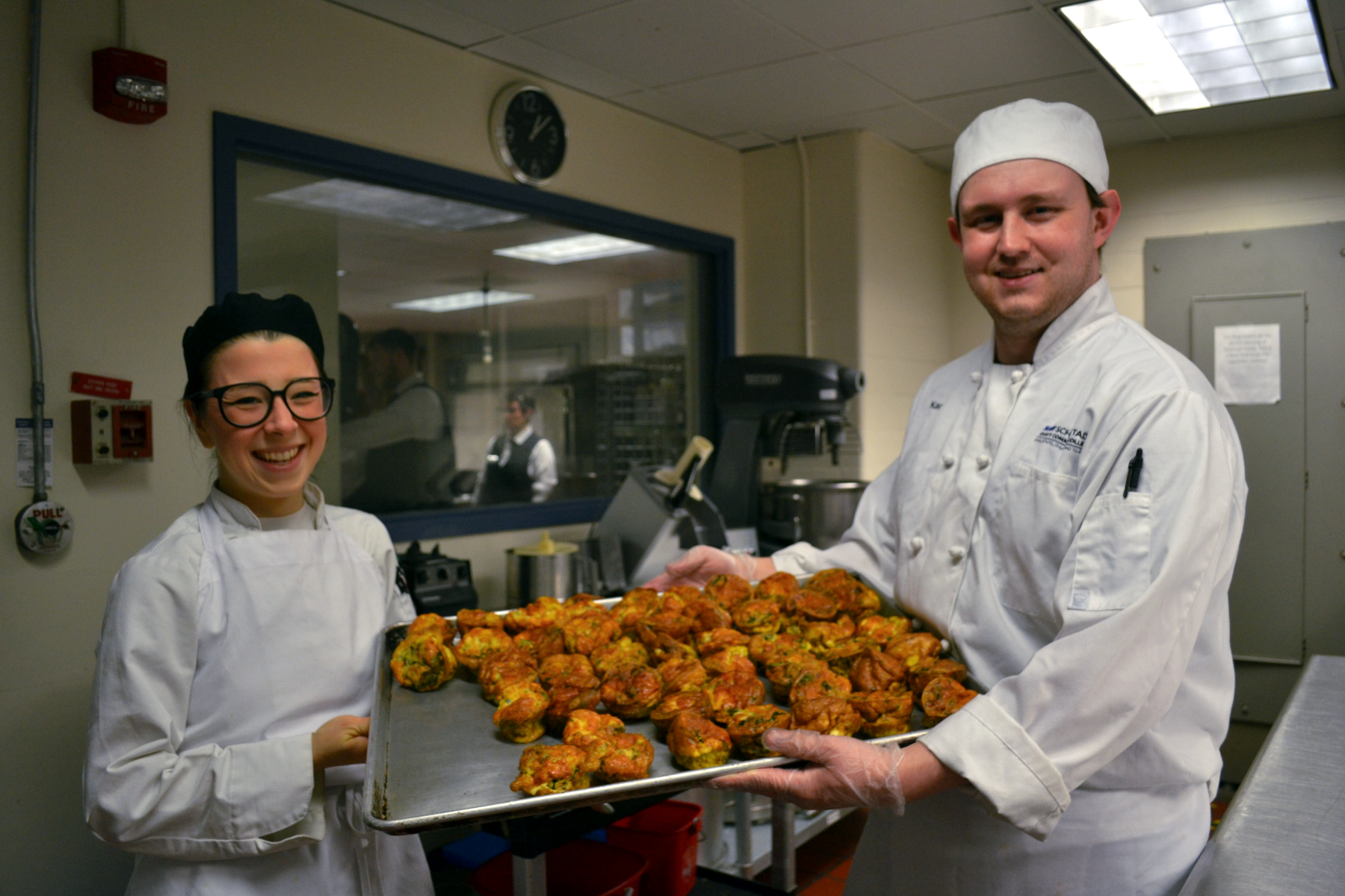 Rain O'Donnell and Karl Lurz with tray of tray of frittatas