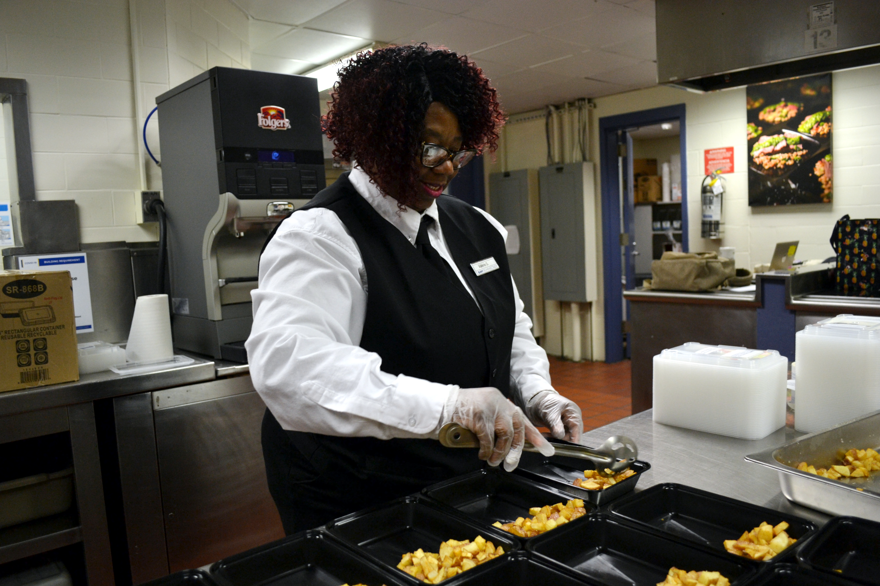 Valerie Smith in Culinary Lab, putting home fries in food container in 