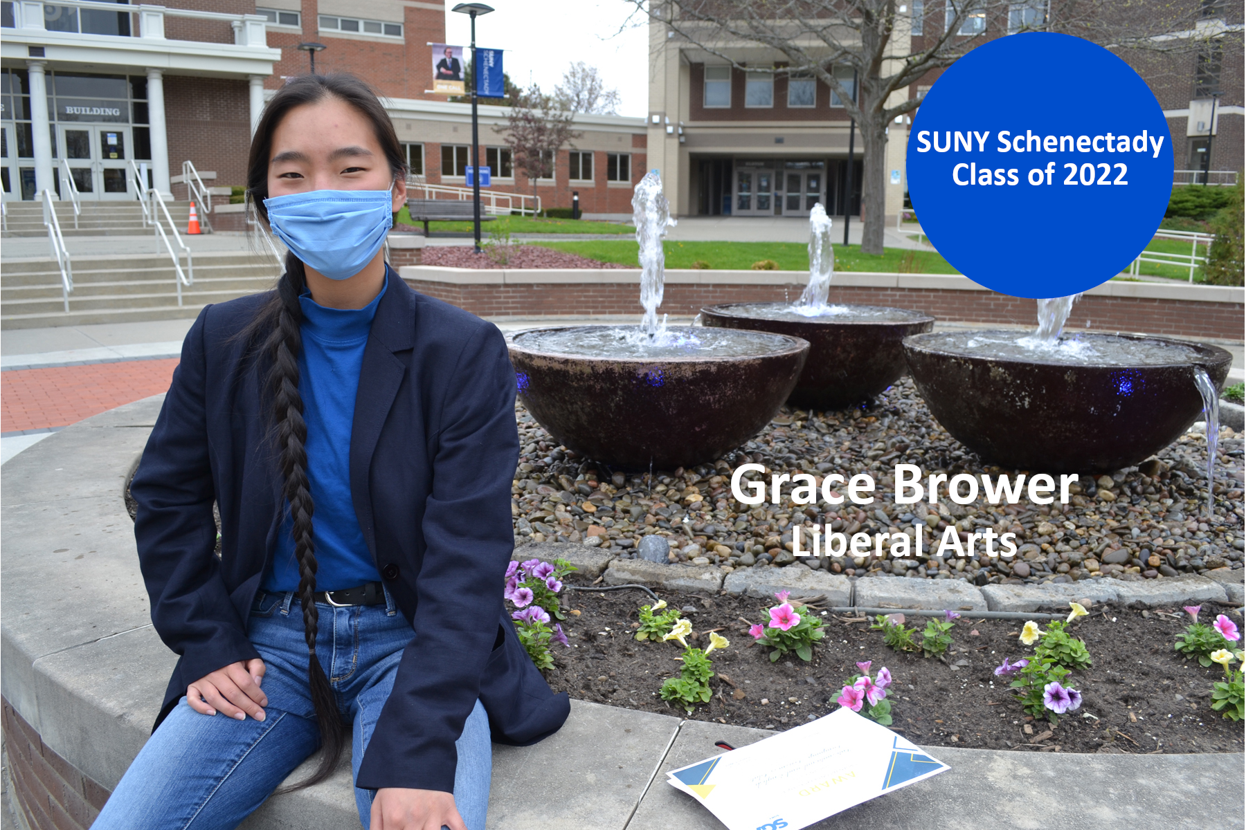 Grace Brower sitting outside near fountain in quad