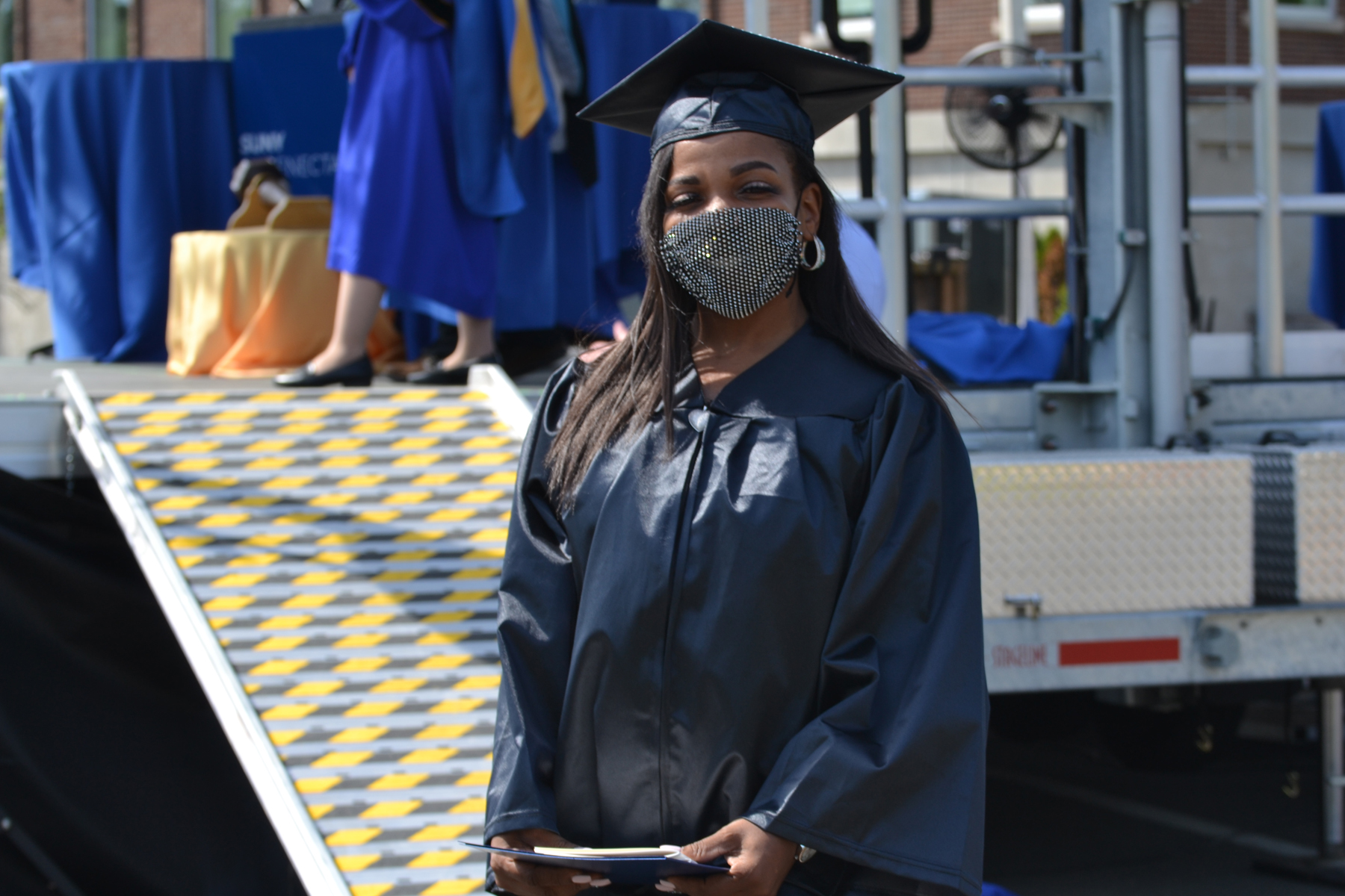 Graduate posing near stage