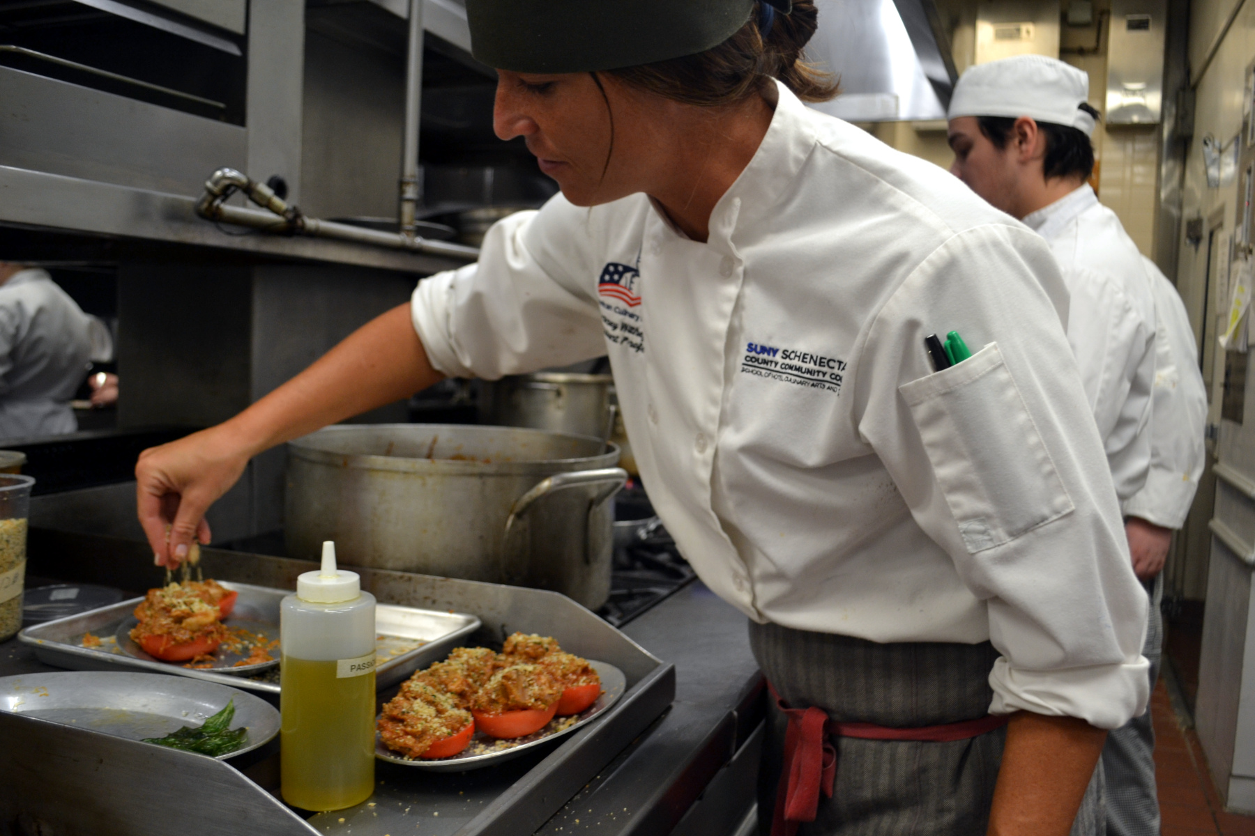 Chef Courtney Withey preparing cuisine for Casola Dining Room