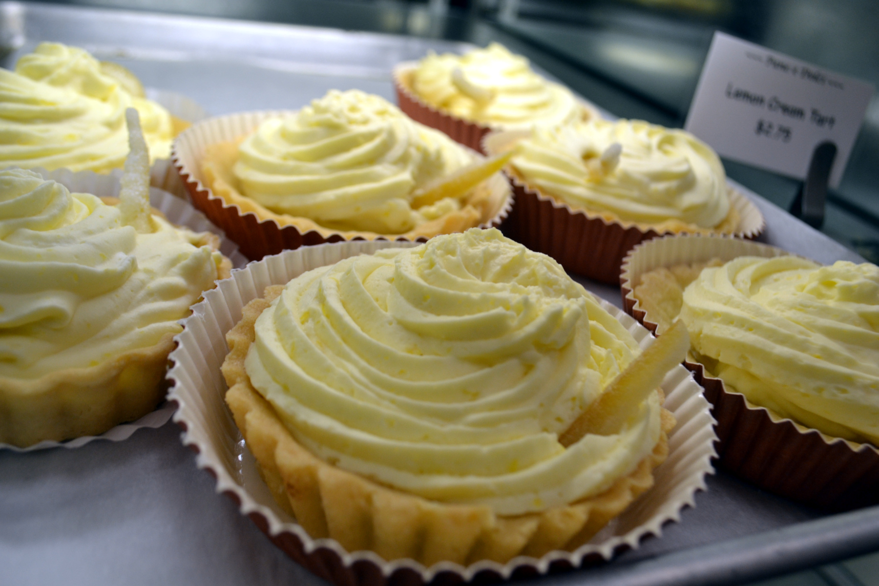 Close up photo of lemon tarts in bakery case