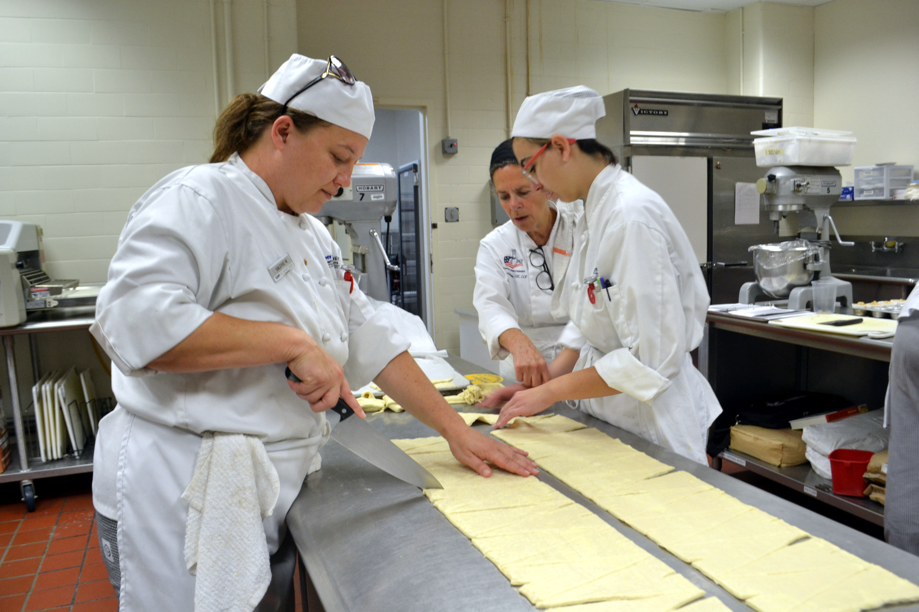 Students and Chef Sue Hatalsky making croissants in Pastry Lab