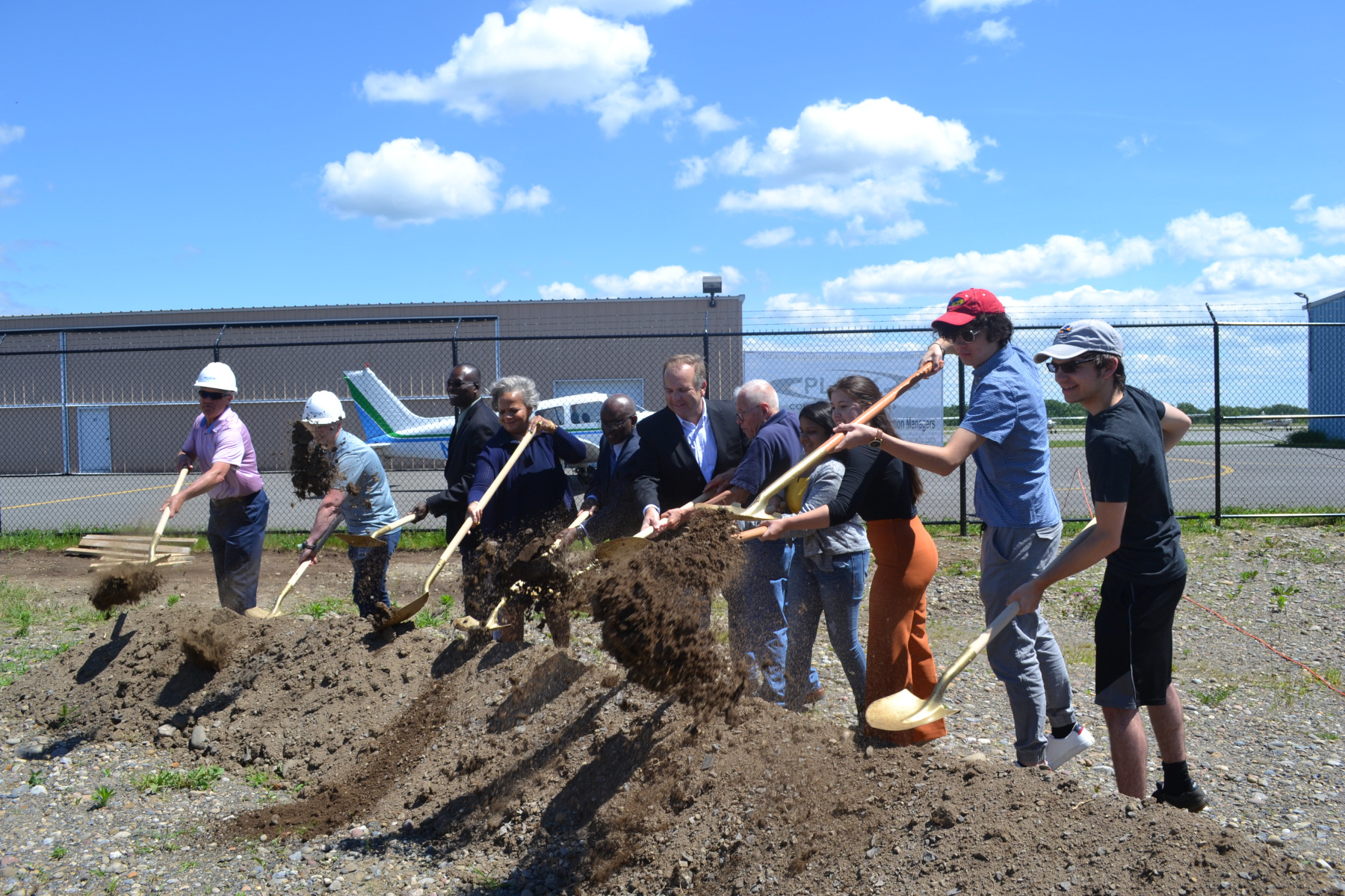 Officials breaking ground on new airport hangar.