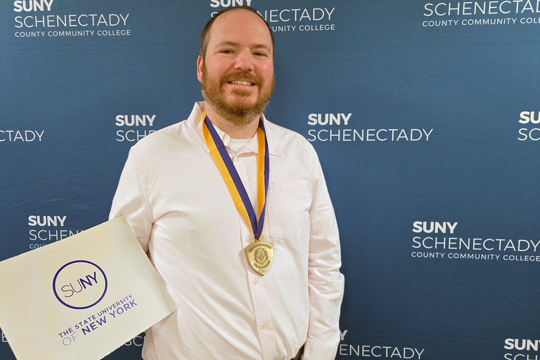 JP Ciejka wearing Chancellor's Award medallion