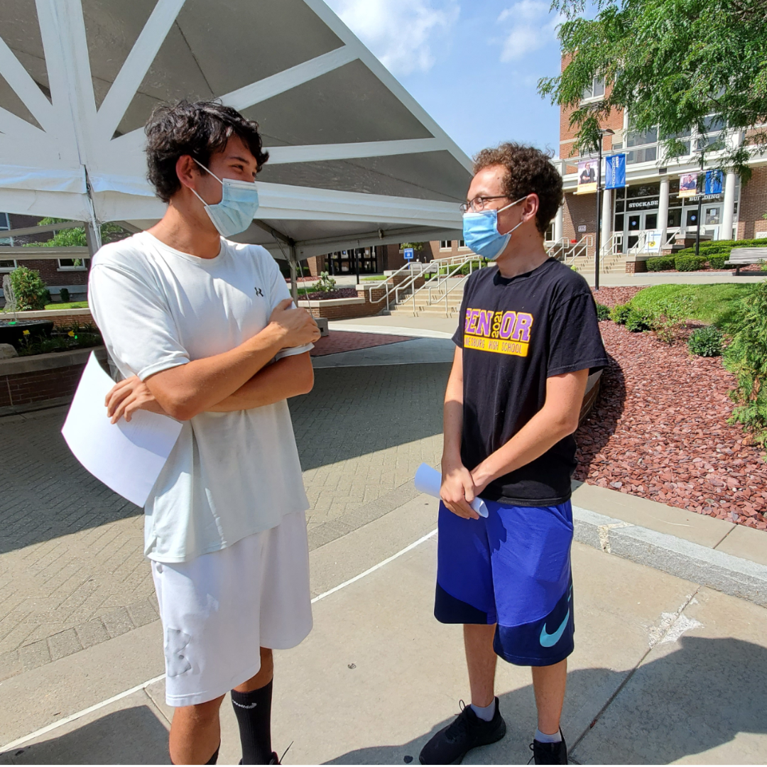 Two students, Jack Salmon and Aaron Maher, standing outside in quad