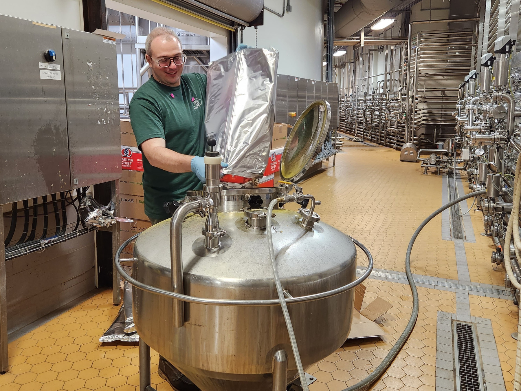 James Hanley using brewing equipment at Dogfish Head Brewery