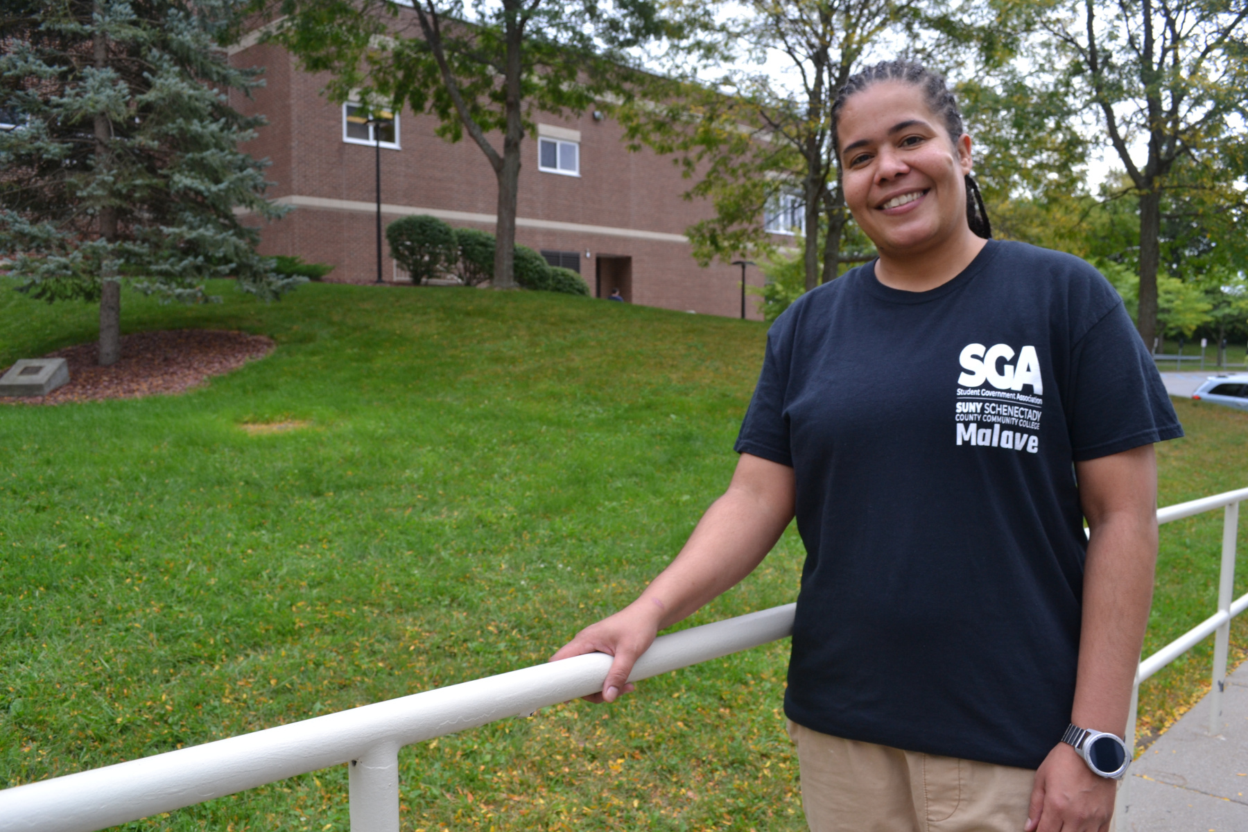 Jennifer Malave standing outside in the quad with SGA tshirt on