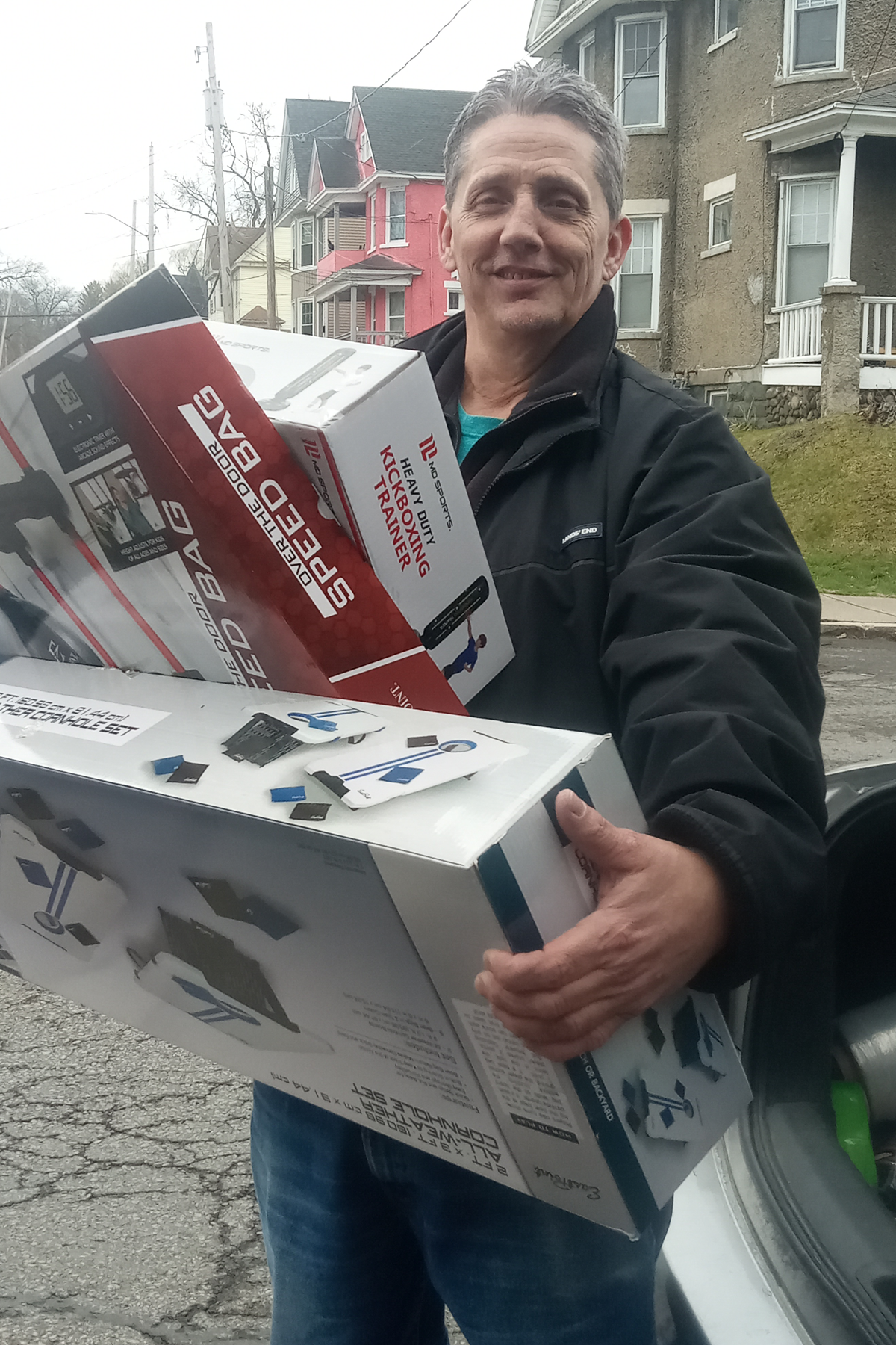 John May carrying items to be donated