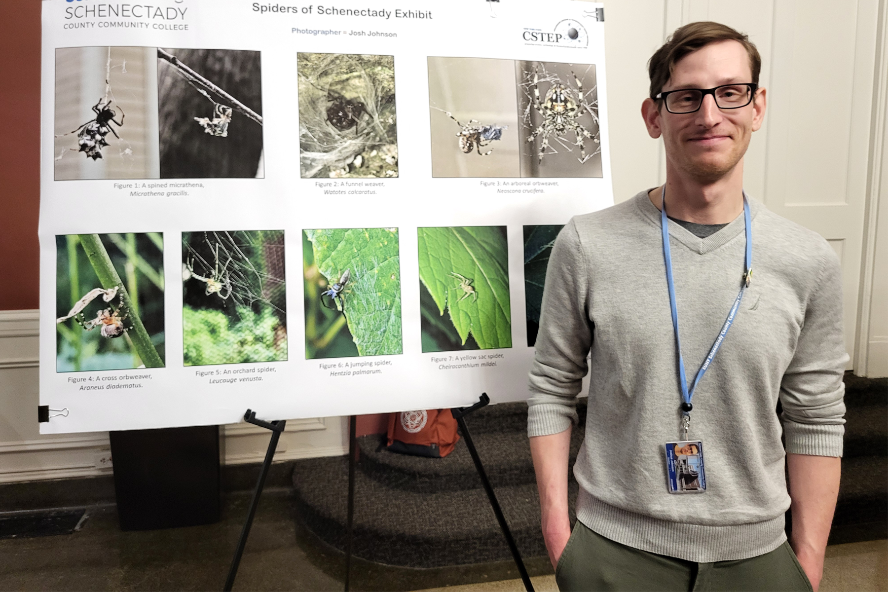 Josh Johnson standing next to his science poster during STEM Day, 