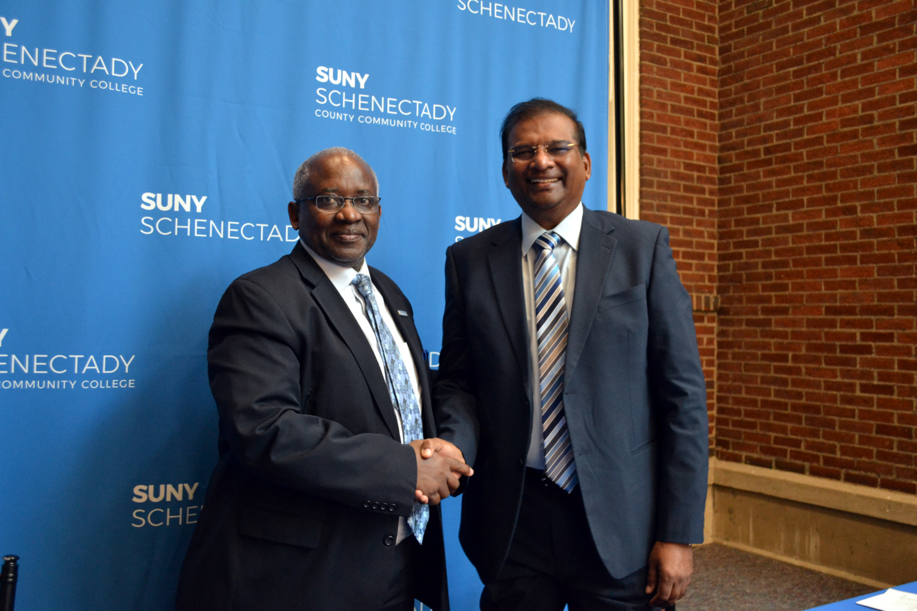 Dr. Steady Moono and Dr. Paul Dhinakaran shaking hands