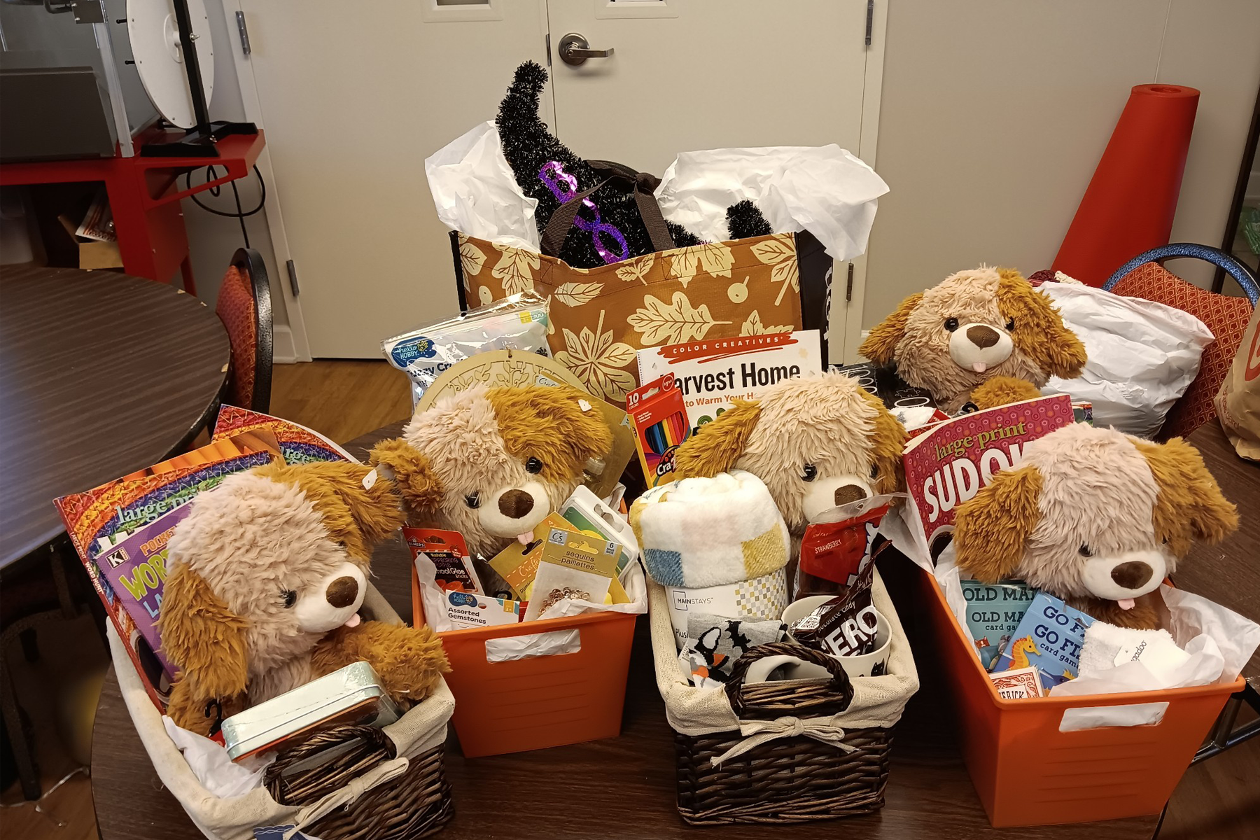 Stuffed animals, puzzles and other items in gift baskets