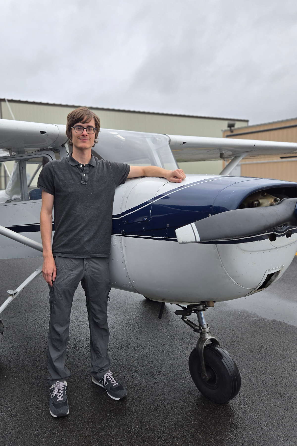 Kyle Barkevich standing in front of airplane
