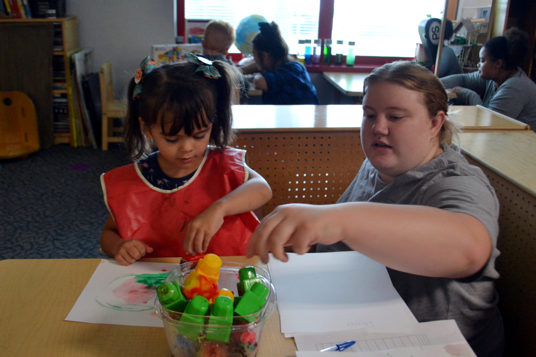 Leah and child seated, STEM activity