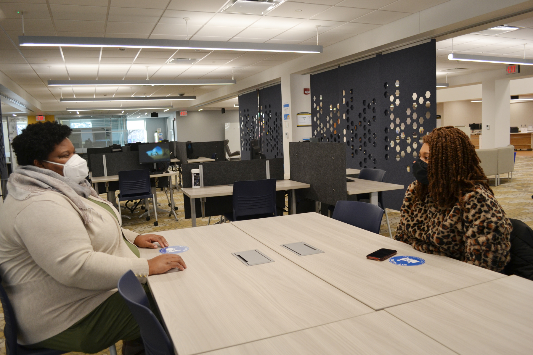 Busi Motau with her mentor Alicia Richardson sitting at a table in the Learning Commons