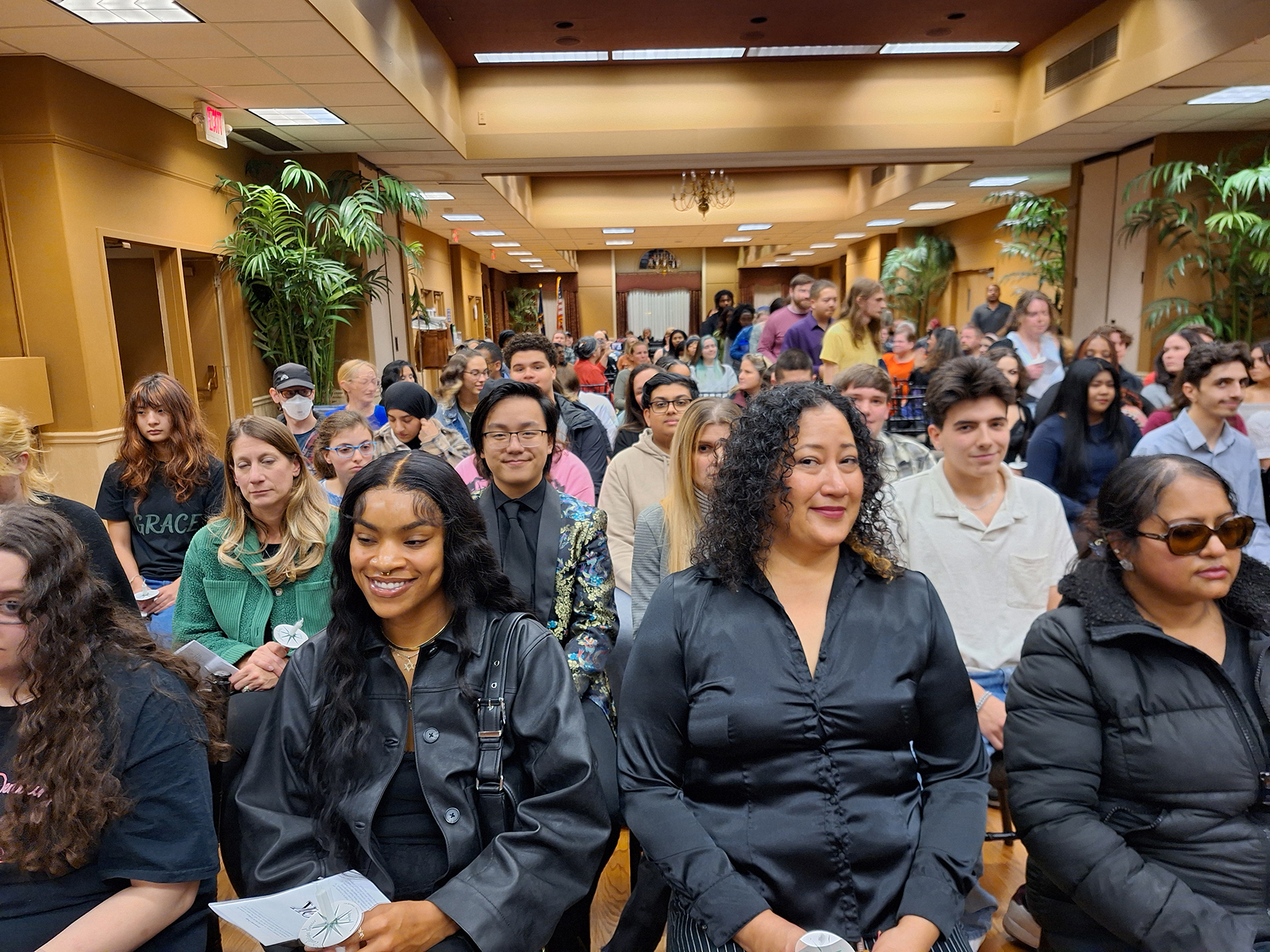 Students seated in rows, smiling