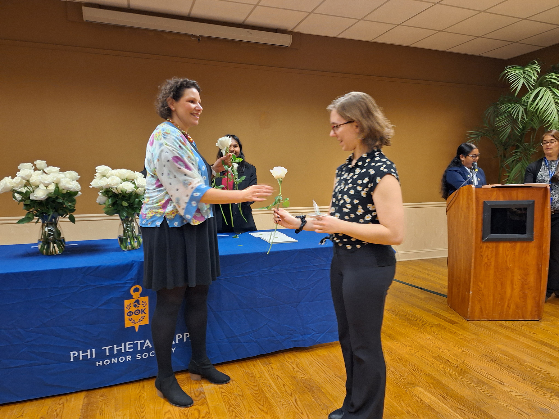 Student standing, receiving certificate