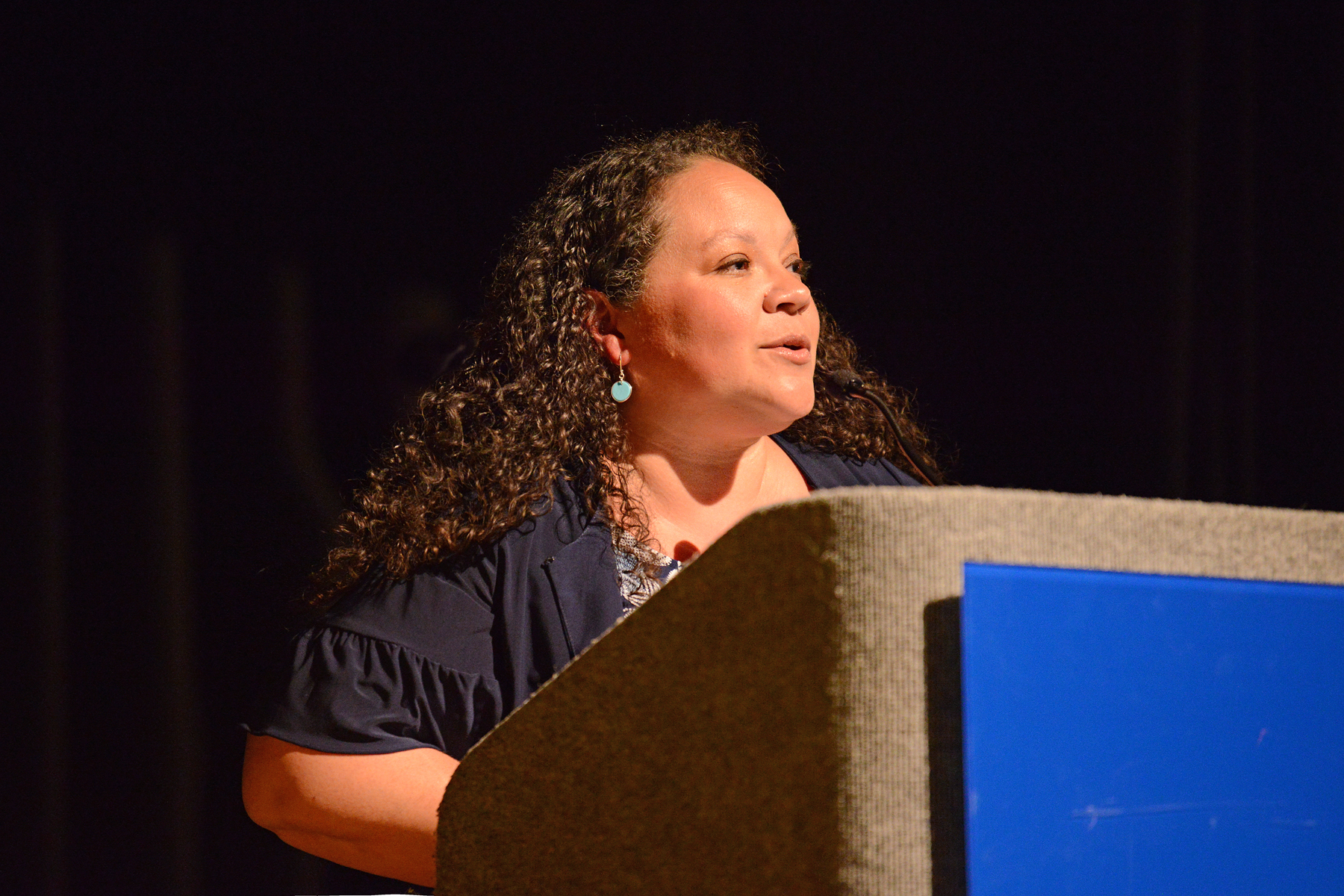 Pam McCall speaking at podium