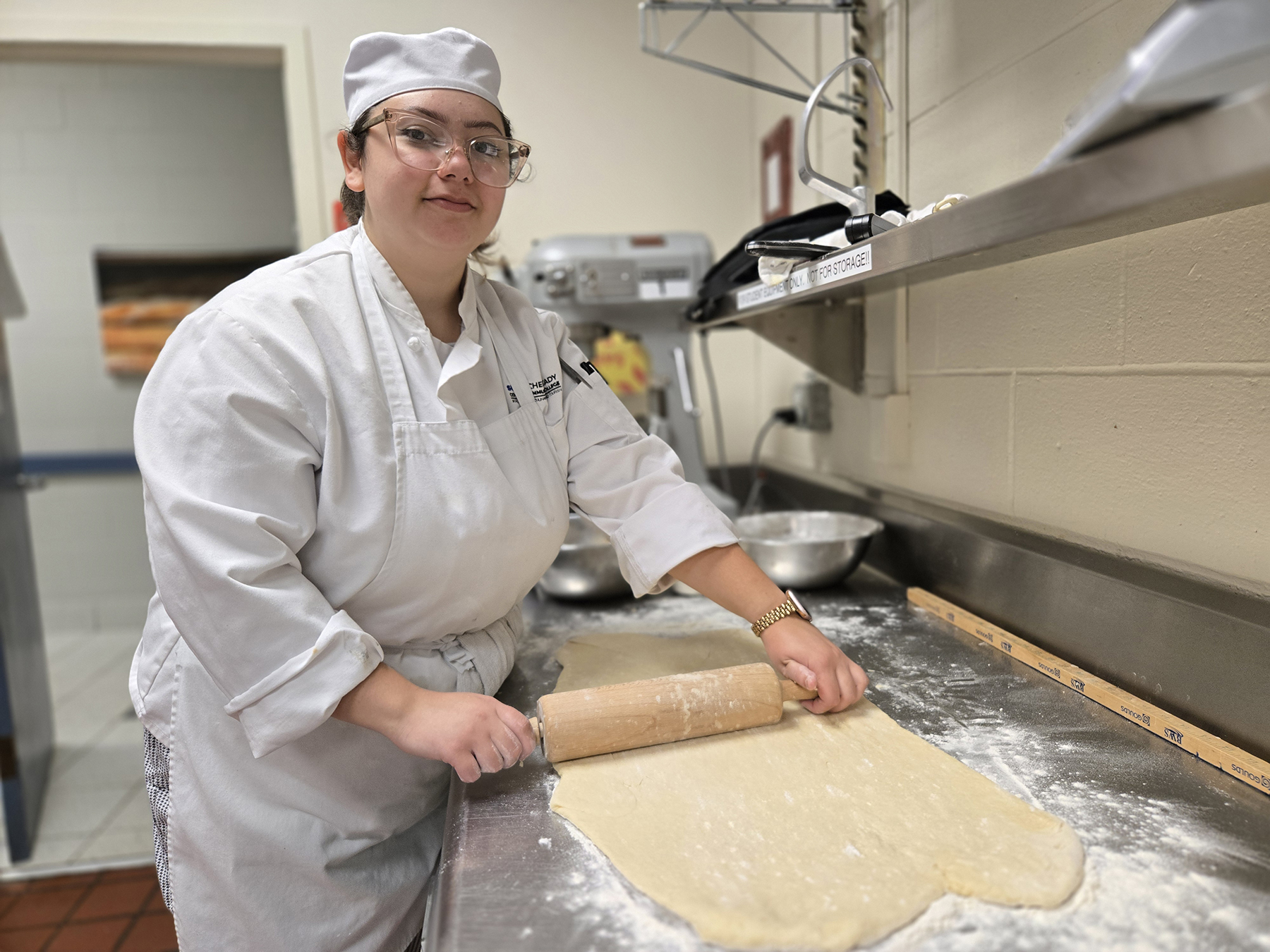 Student rolling out dough