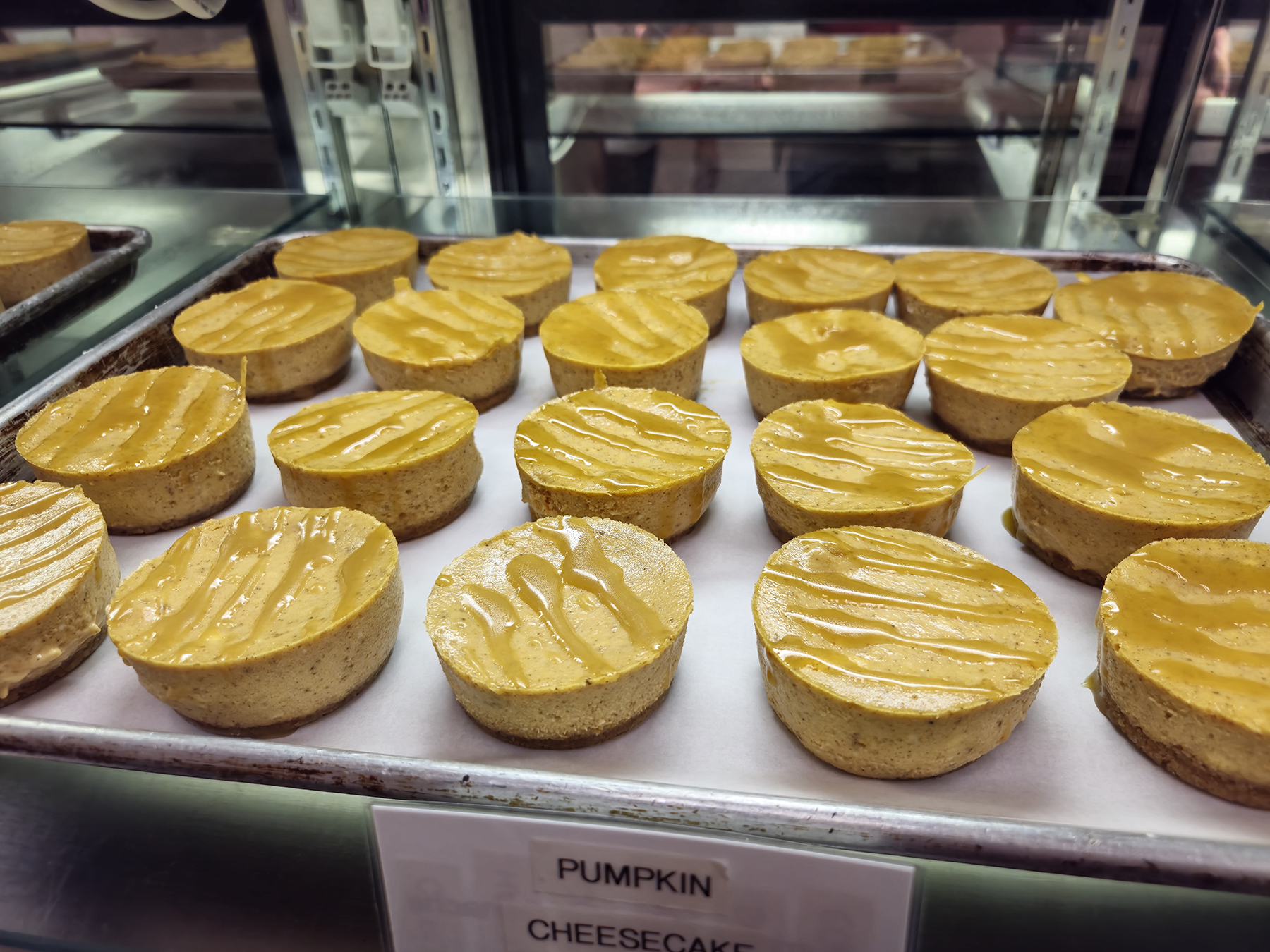 Tray of pumpkin cheesecake inside bakery