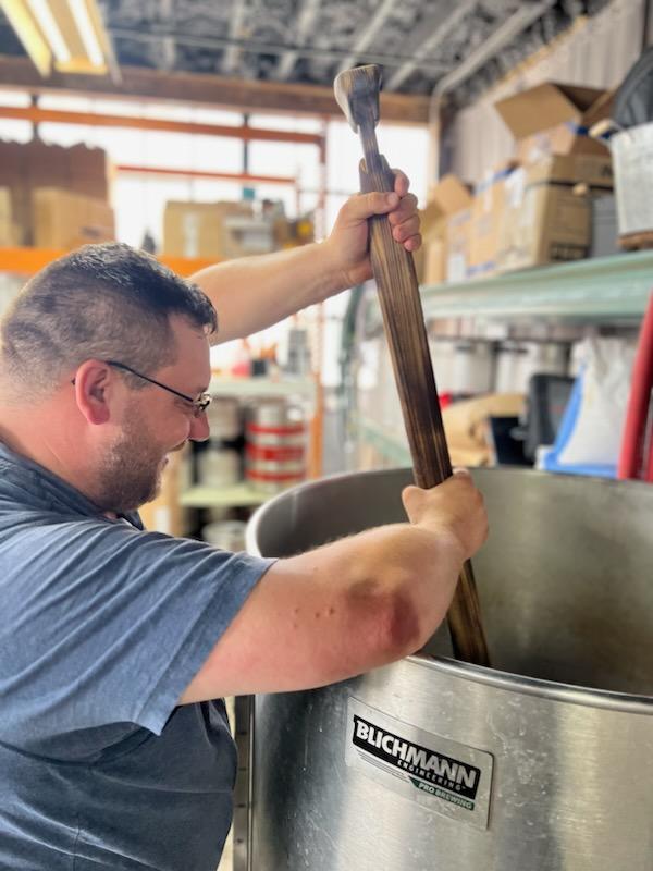Pete Woznack using the brewing equipment at Speckled Pig Brewing Company