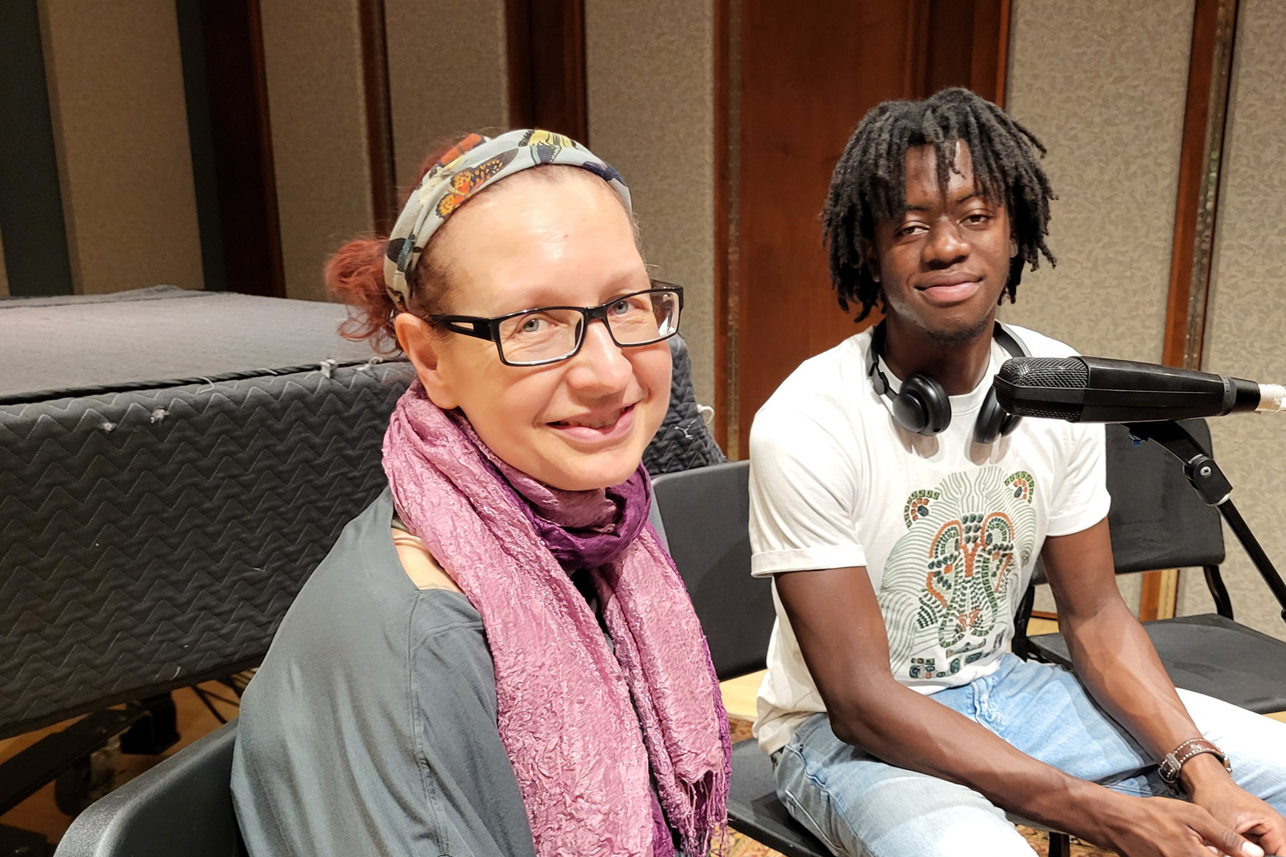 Podcast co-hosts Dr. Babette Faehmel and Alexandre Lumbala, seated in recording studio