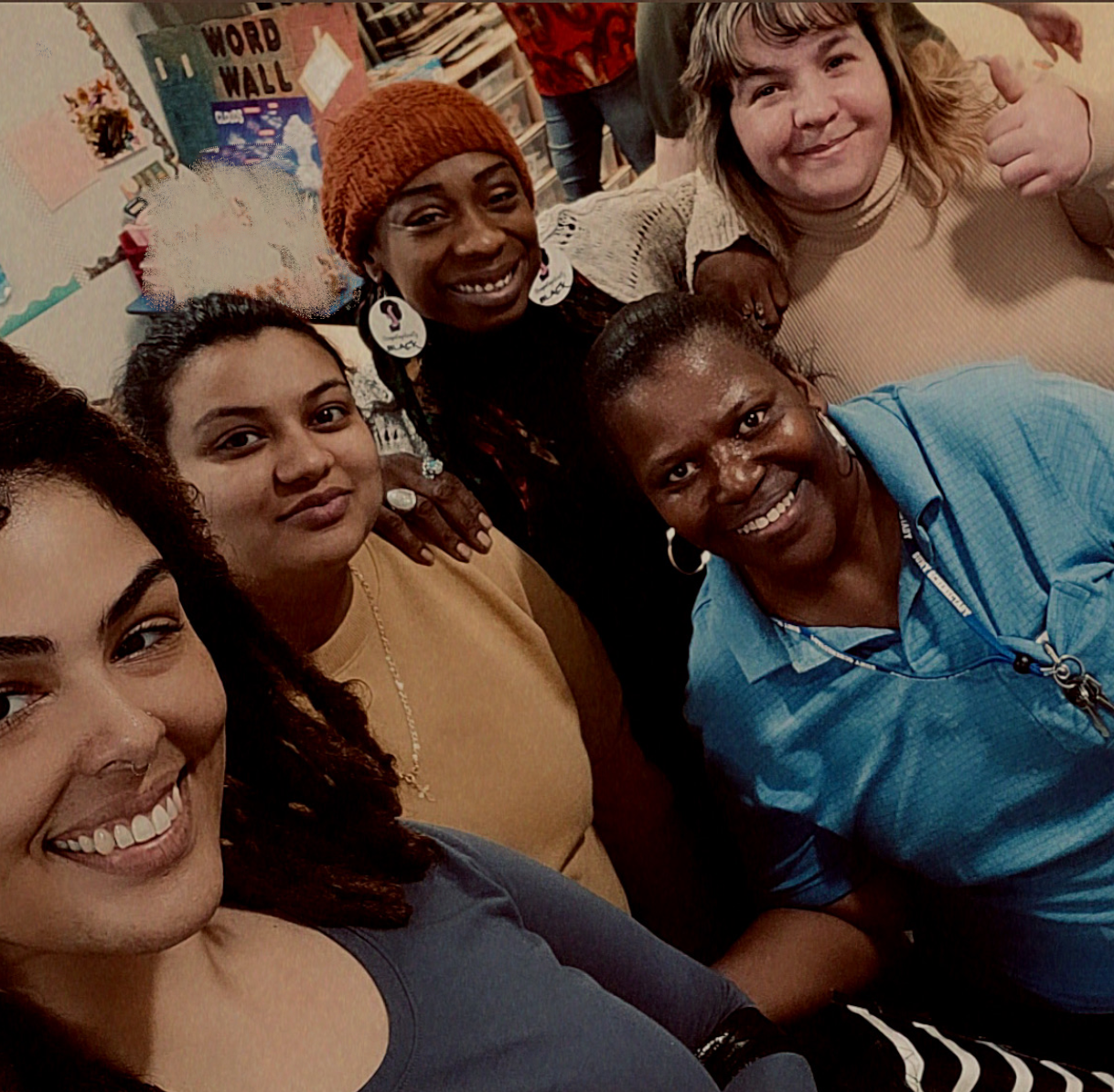 Students smiling at camera, inside YWCA Childcare Center